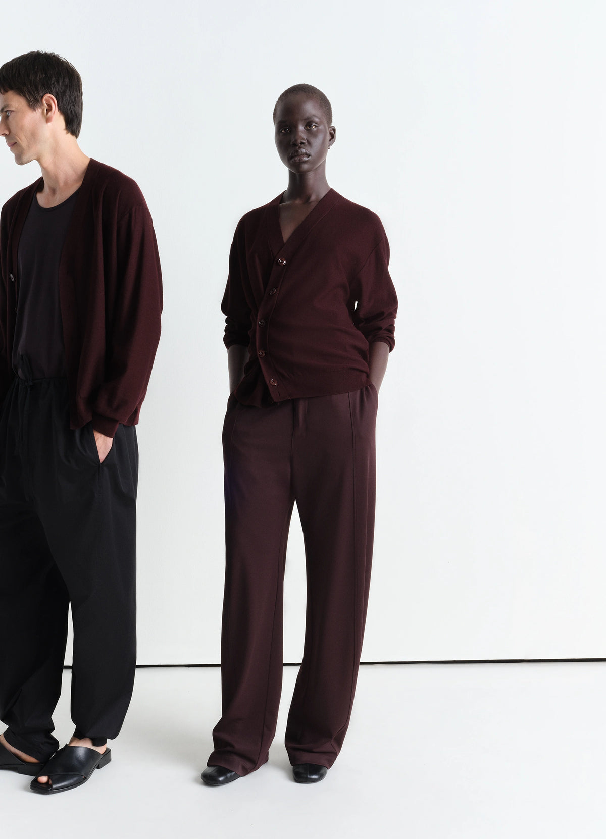 Lemaire Relaxed Twisted Cardigan in Bordeaux Merino Wool Blend, model shot, front view asymmetric button placket