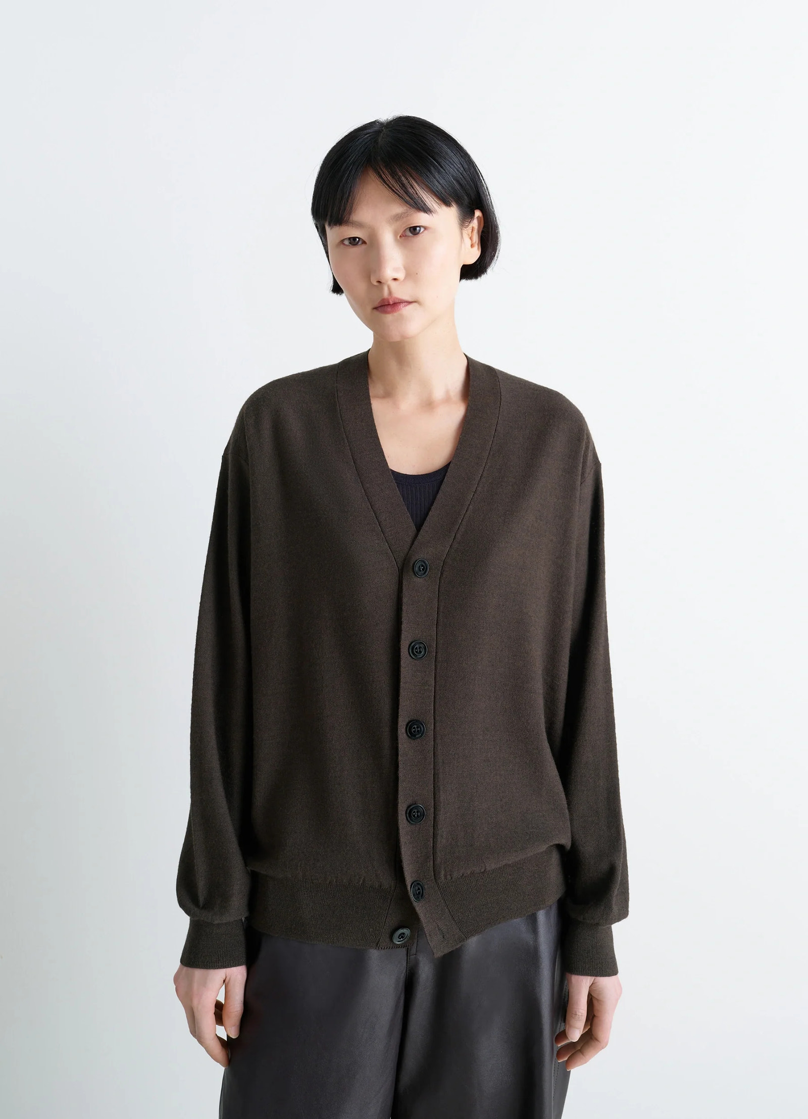 Lemaire relaxed twisted cardigan in knitted merino wool, model shot, three-quarter view dropped shoulders