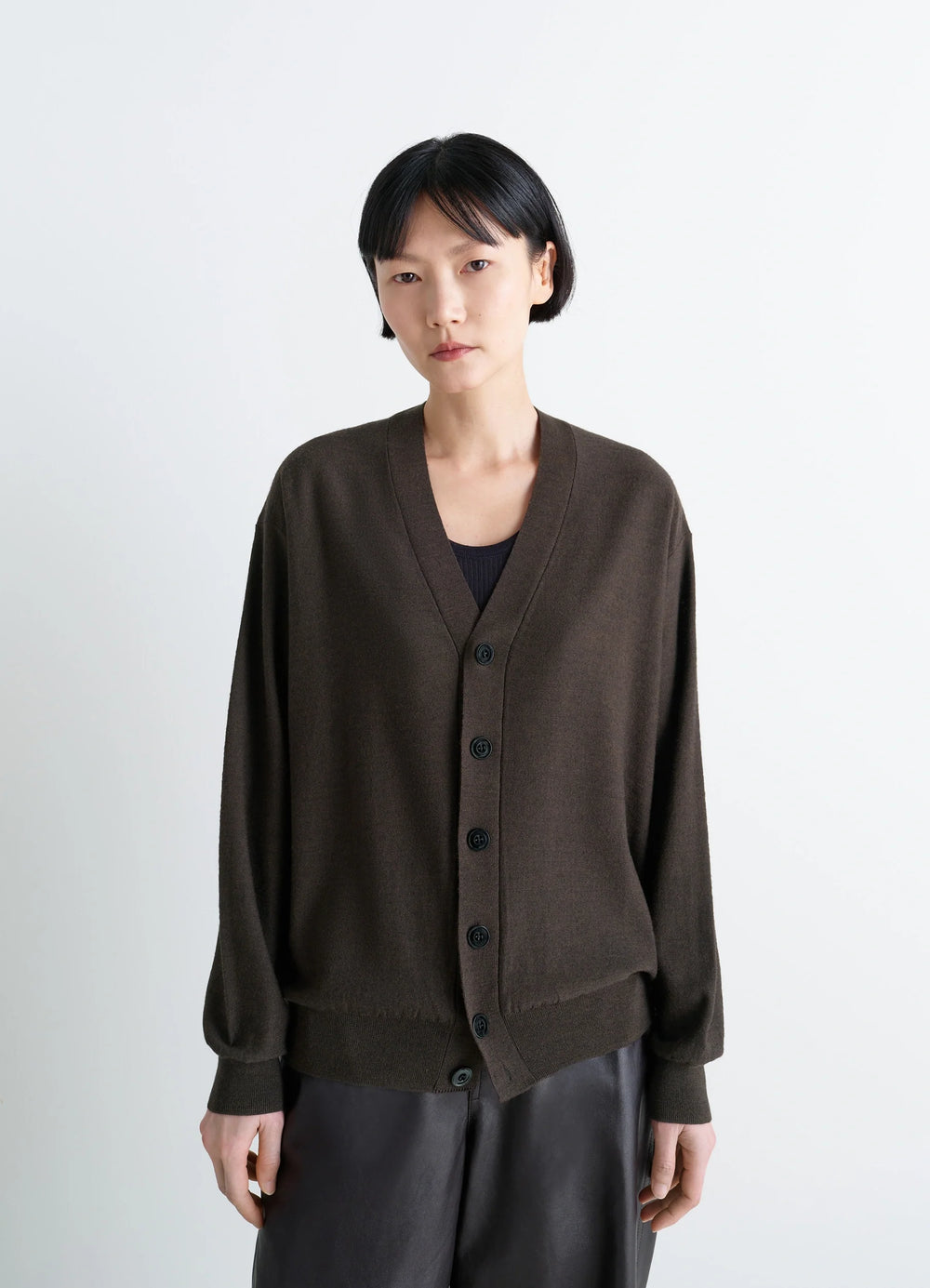 Lemaire Relaxed Twisted Cardigan in Knitted Merino Wool, model shot, three-quarter view dropped shoulders