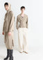Lemaire Relaxed Twisted Cardigan in Light Beige Blended Merino Wool, model shot, Front view Asymmetrical button placket