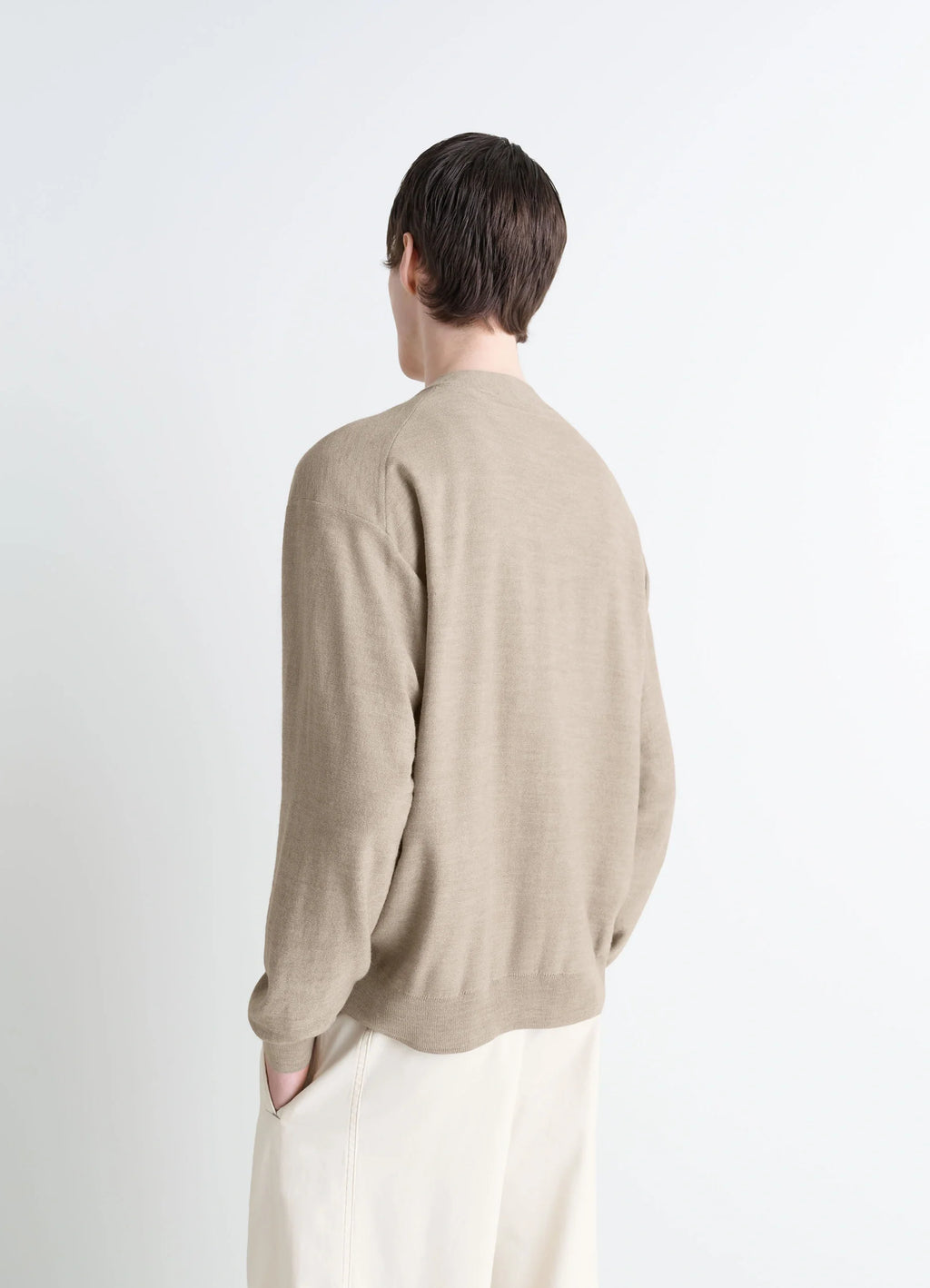 Lemaire Relaxed Twisted Cardigan in Light Beige Blended Merino Wool, model shot, back view minimalist back detail