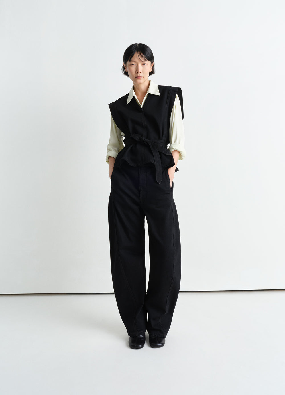 Lemaire Chasuble in Deep Black Twill Denim, model shot, three-quarter view belted waist layering