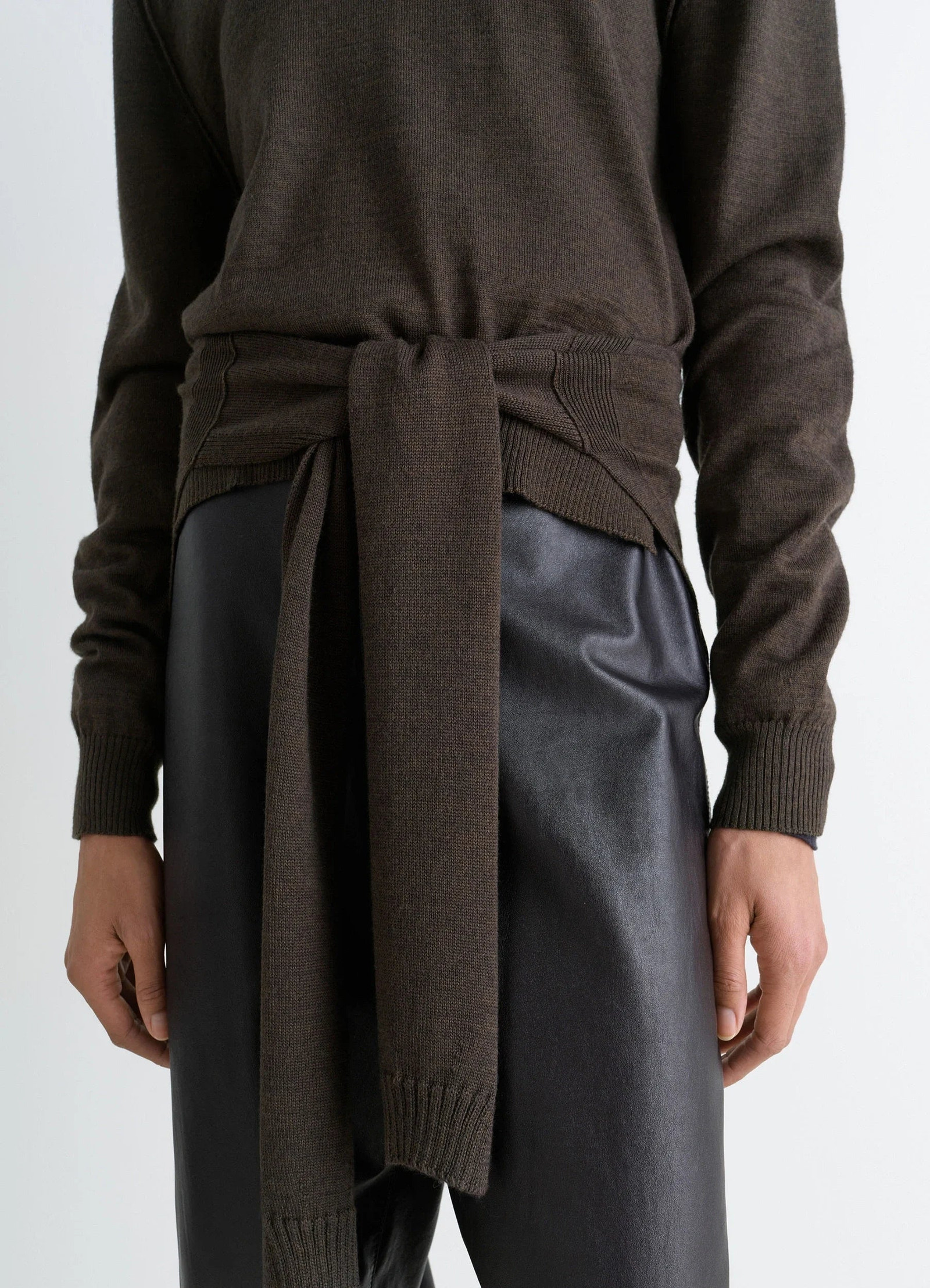 Trompe loeil crew neck jumper in blended merino wool, model shot, close-up waist view layered knit tie detail