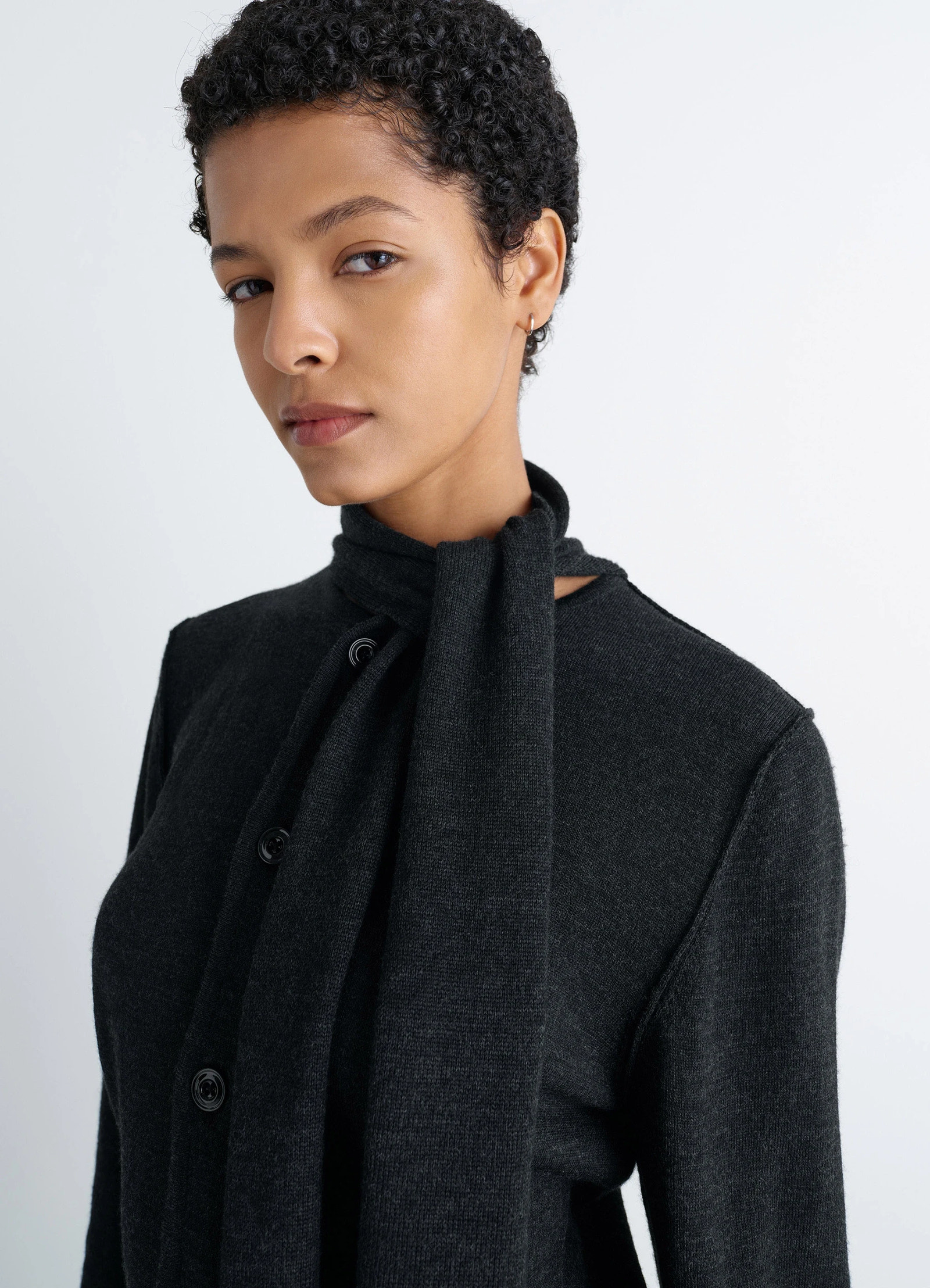 Lemaire twisted cardigan with scarf in merino wool blend, model shot, close-up side view integrated scarf detail
