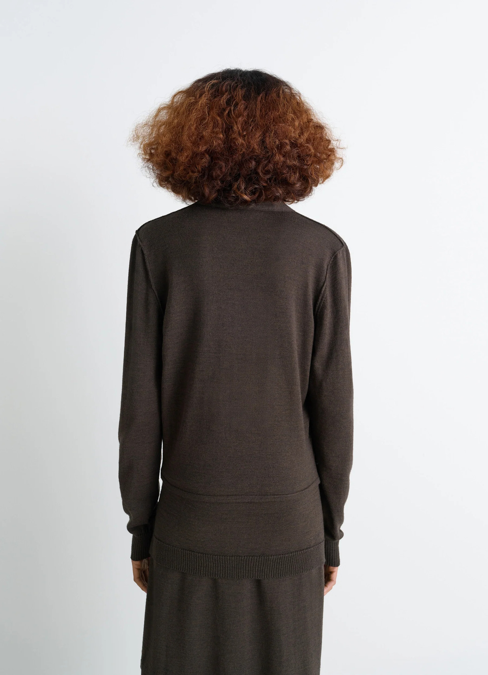 Lemaire twisted cardigan in blended merino wool, model shot, back view ribbed cuffs