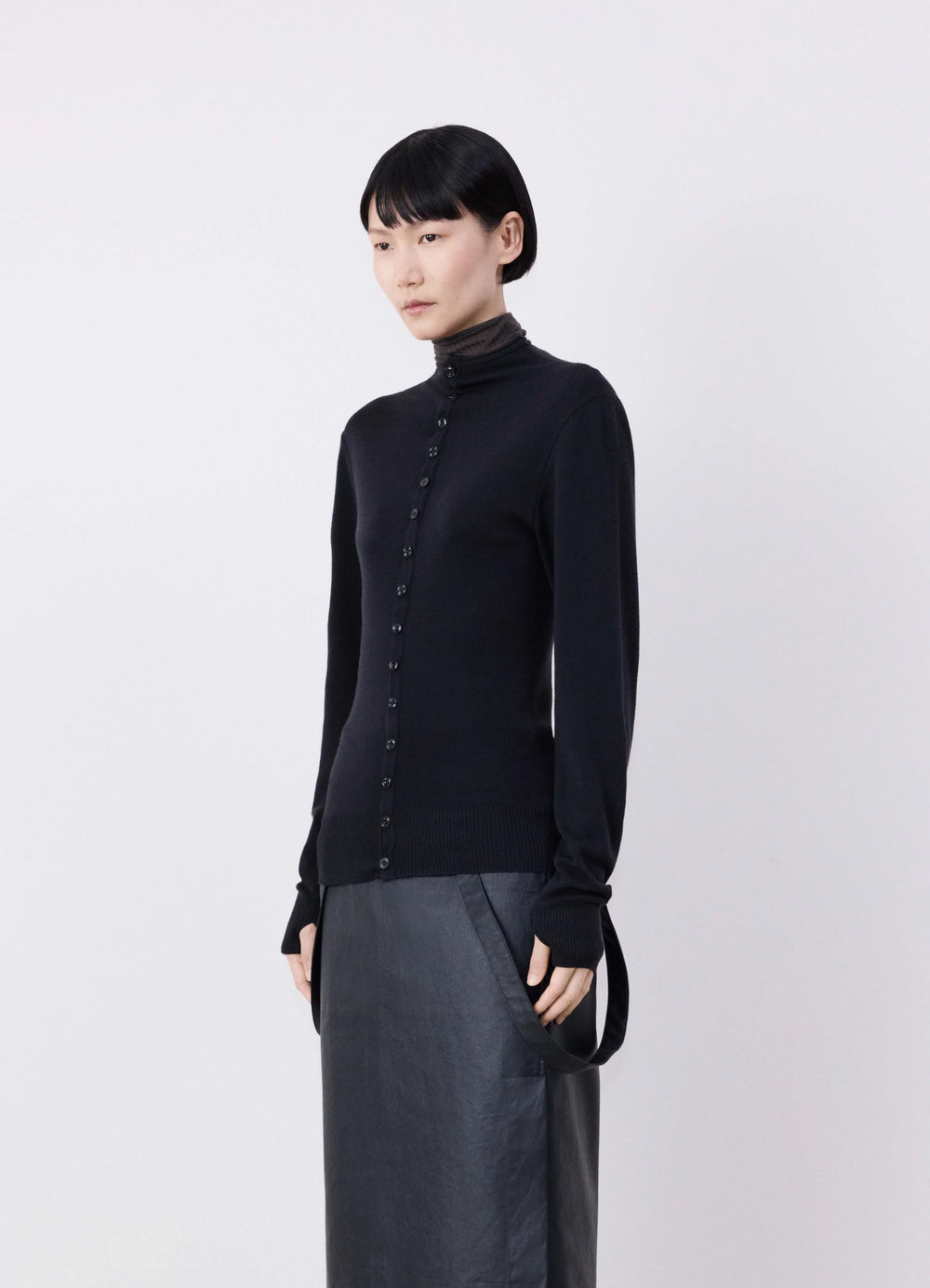 Lemaire Fitted Seamless Cardigan in Black Merino Wool, model shot, Side front view Fitted with thumbholes