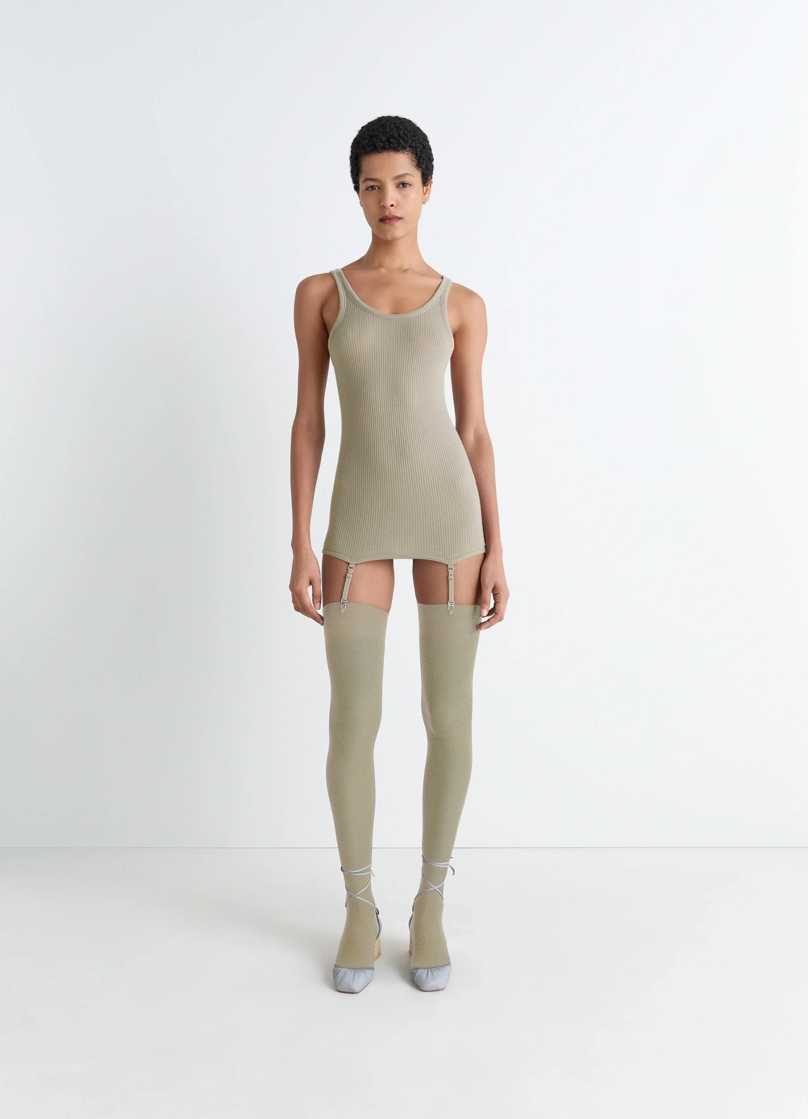 Lemaire seamless tank top in beige ribbed merino wool, model shot, full body view seamless tank with suspenders