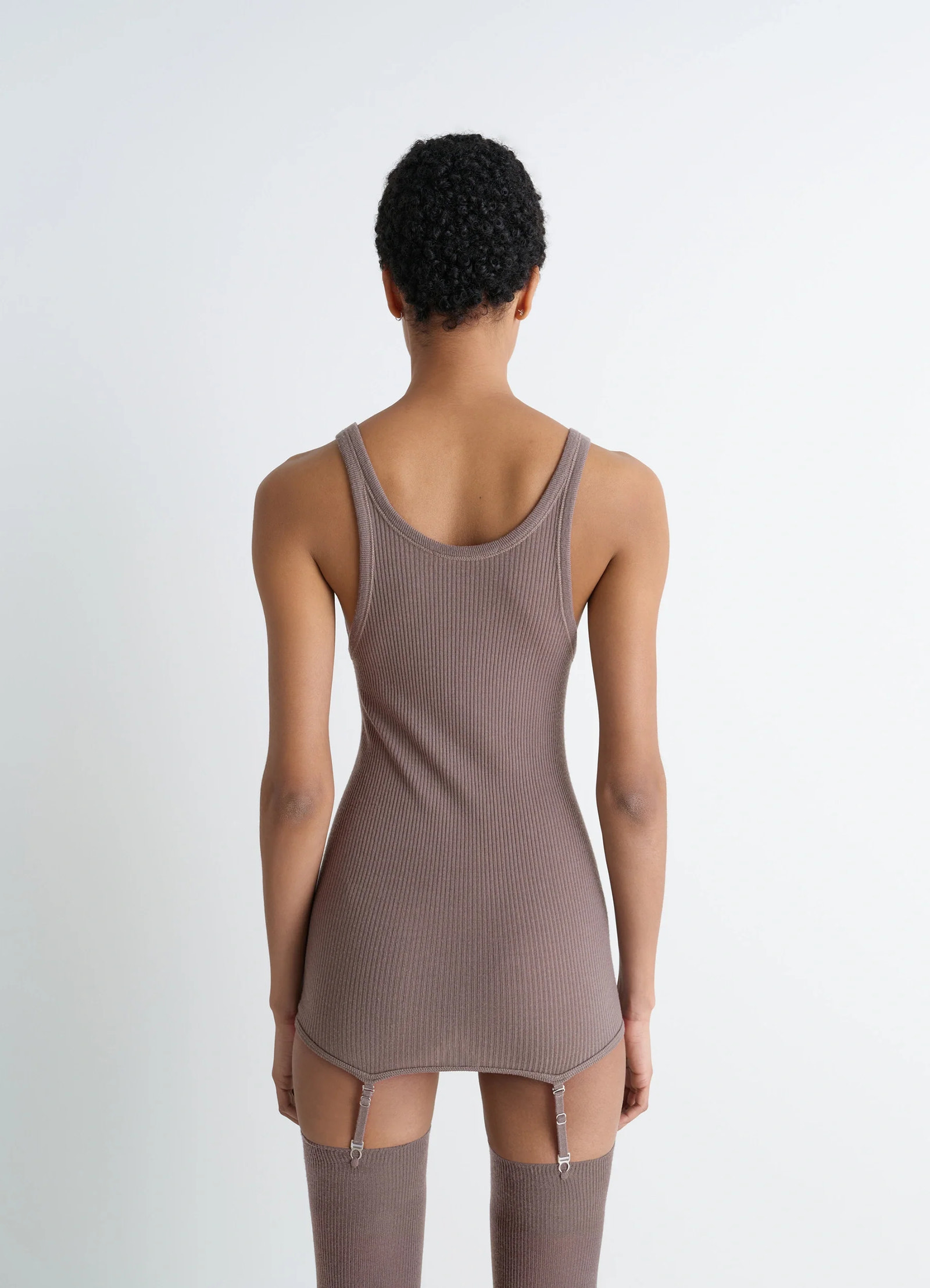 Lemaire seamless short sleeves tank in fine ribbed merino wool, model shot, back view fitted with suspenders