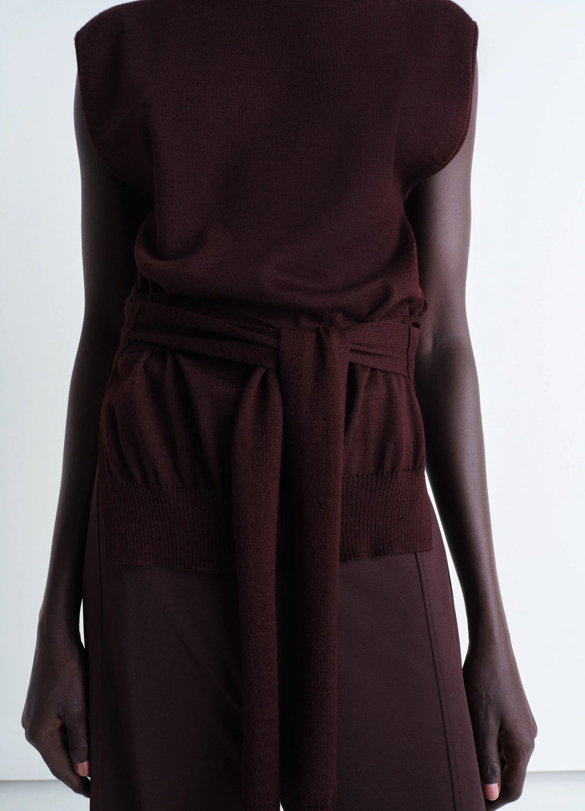Trompe Loeil Sleeveless Jumper in Dark Burgundy Knit, model shot, Back view Waist tie detail