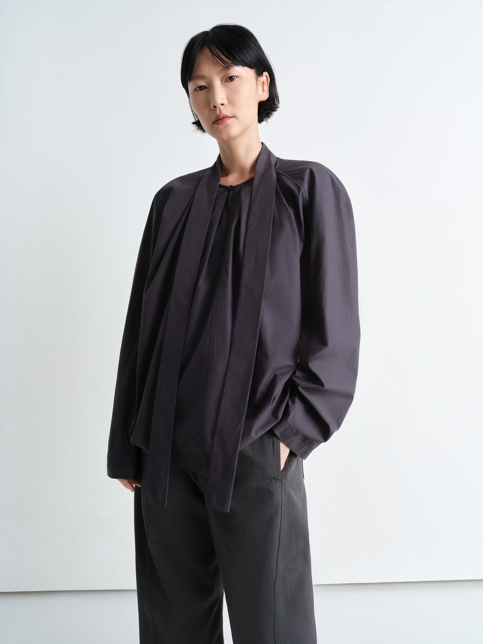 Lemaire ascot blouse in lightweight washed cotton poplin, model shot, front view rounded fit with ascot tie