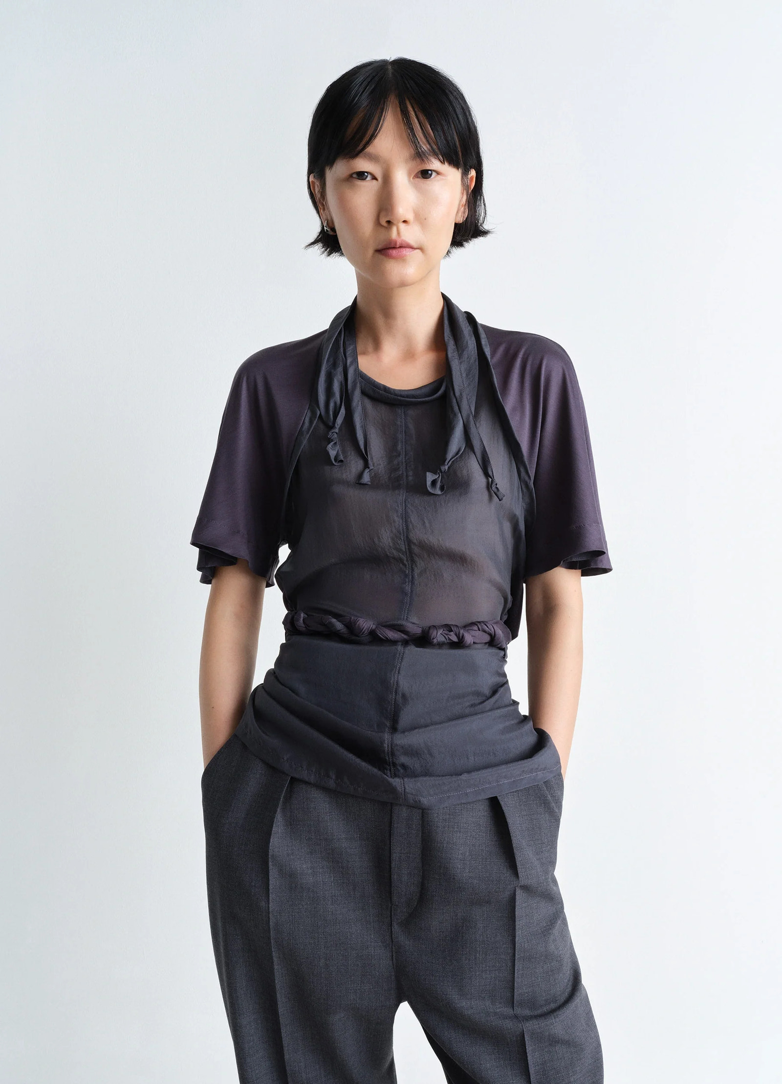 Lemaire mixed fabric knotted top in silk chiffon and jersey, model shot, three-quarter view braided belt detail
