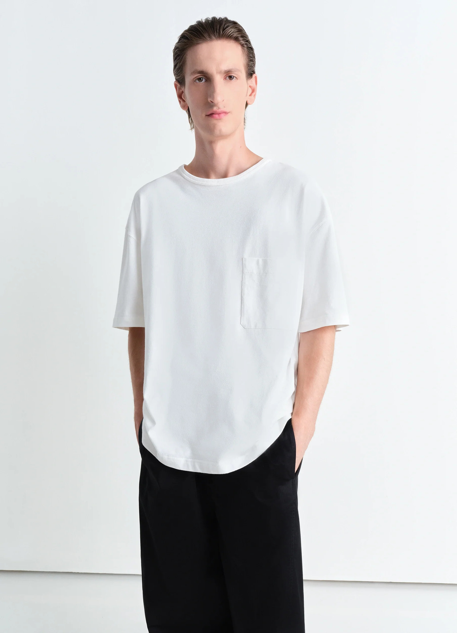 Lemaire boxy short sleeve t-shirt in white linen cotton jersey, model shot, front view patch pocket, rib neckline