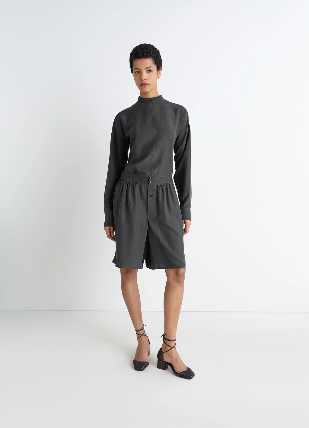 Light Plastron Top in Black Silk Pongee, model shot, three-quarter view high neck, cuffed sleeves
