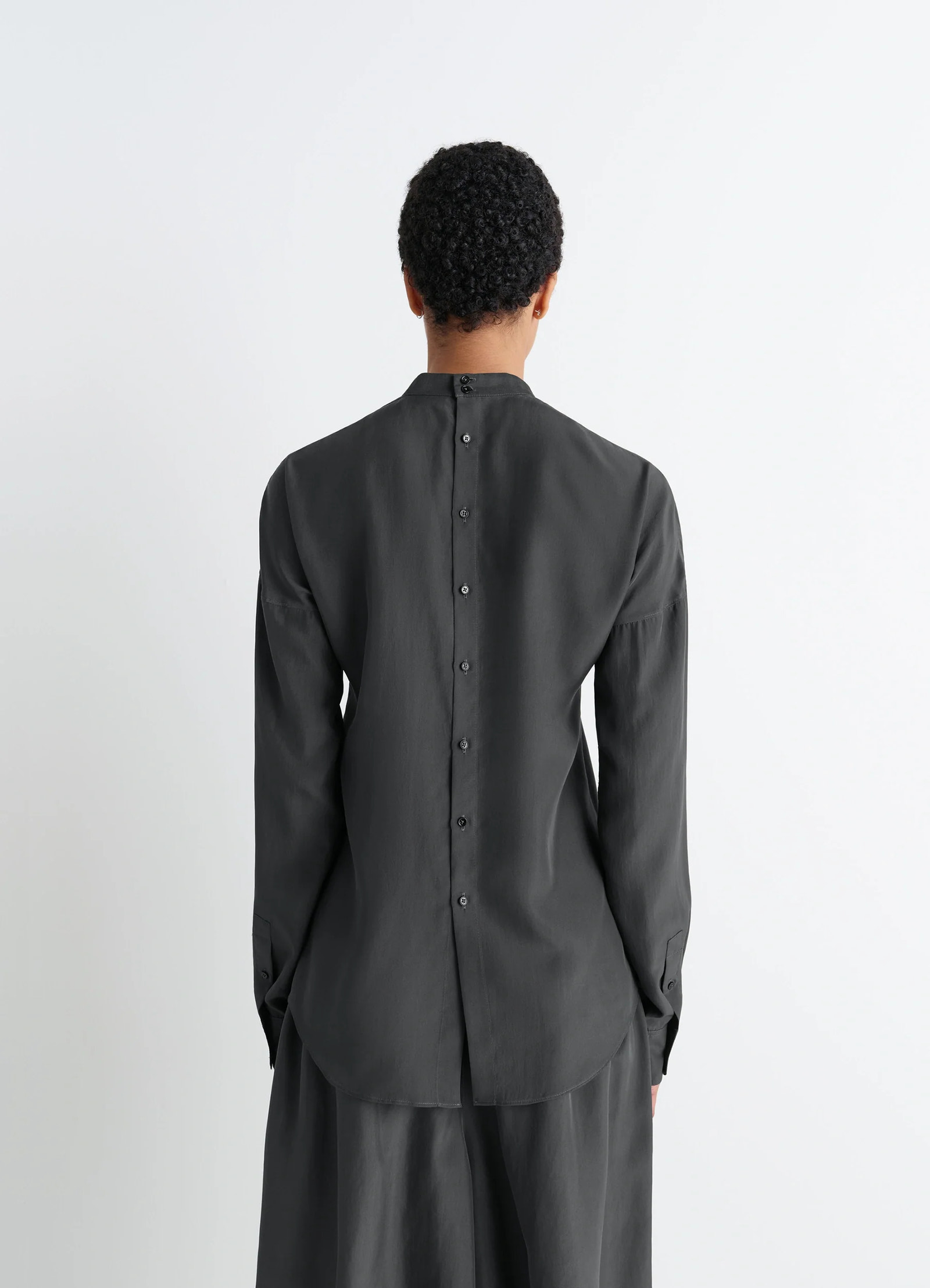 Light plastron top in black silk pongee, model shot, back full view rounded back hem