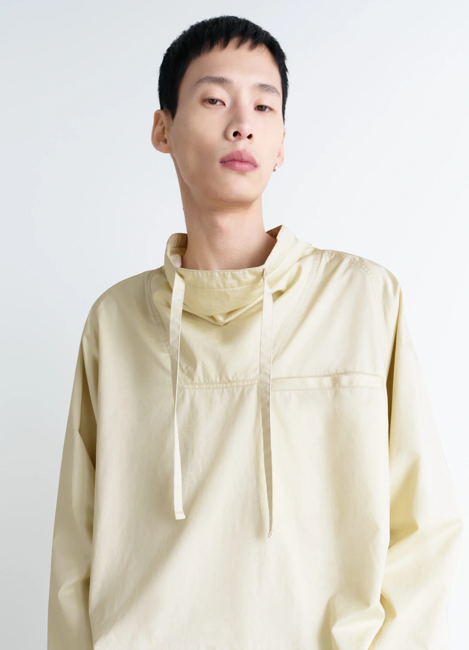 Lemaire funnel neck vareuse in lightweight cotton satin, model shot, close-up view drawstring neck detail