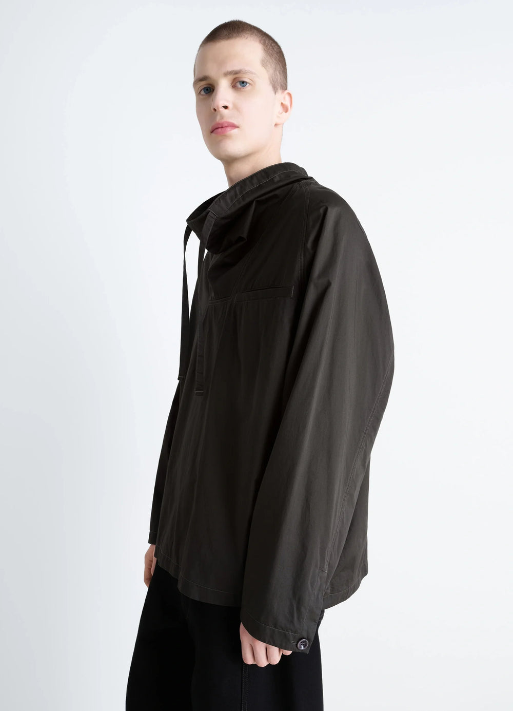 Lemaire Funnel Neck Vareuse in Dark Olive Lightweight Cotton, model shot, side profile button cuff