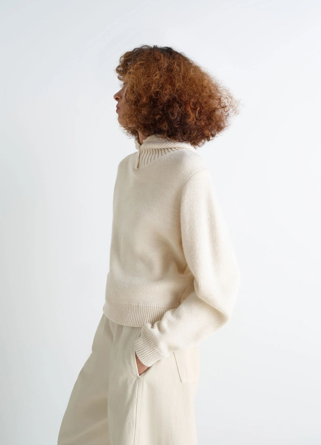 Lemaire Hooded Sweater in Cream Wool Alpaca Blend, model shot, three-quarter view ribbed neck and cuffs