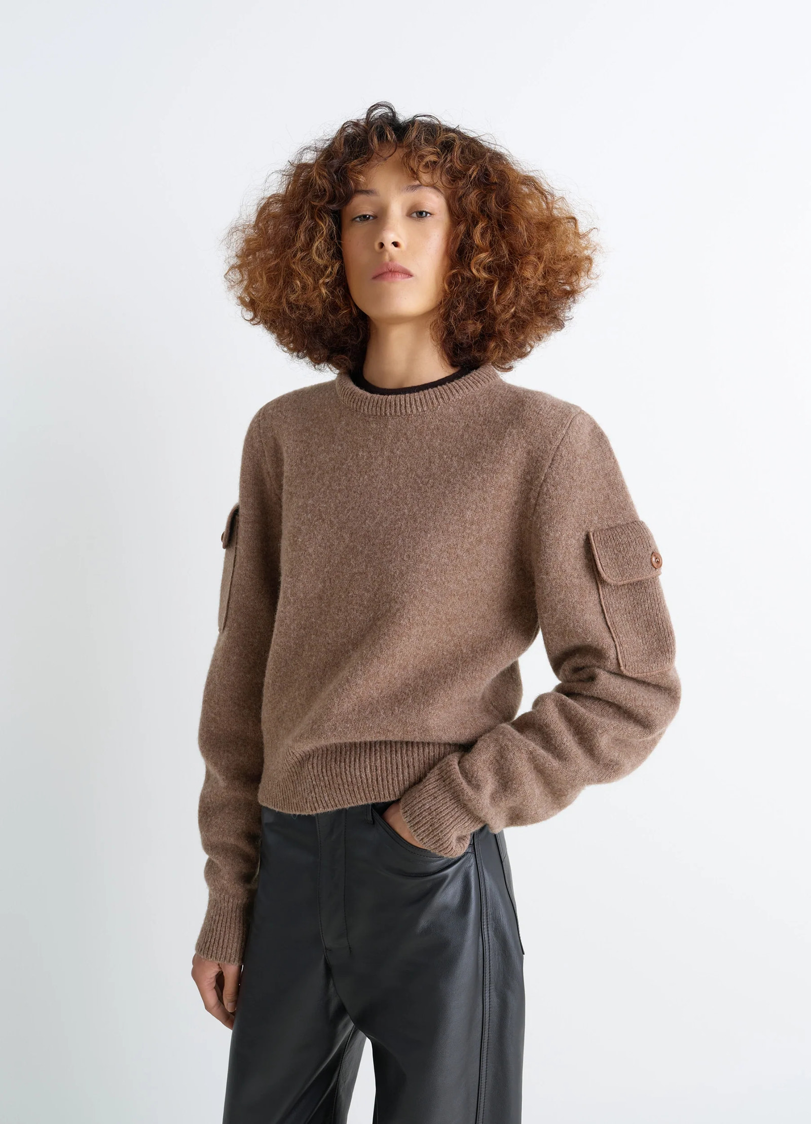 Shetland wool pocketed sweater in brown shetland wool, model shot, front side view pocketed long sleeves