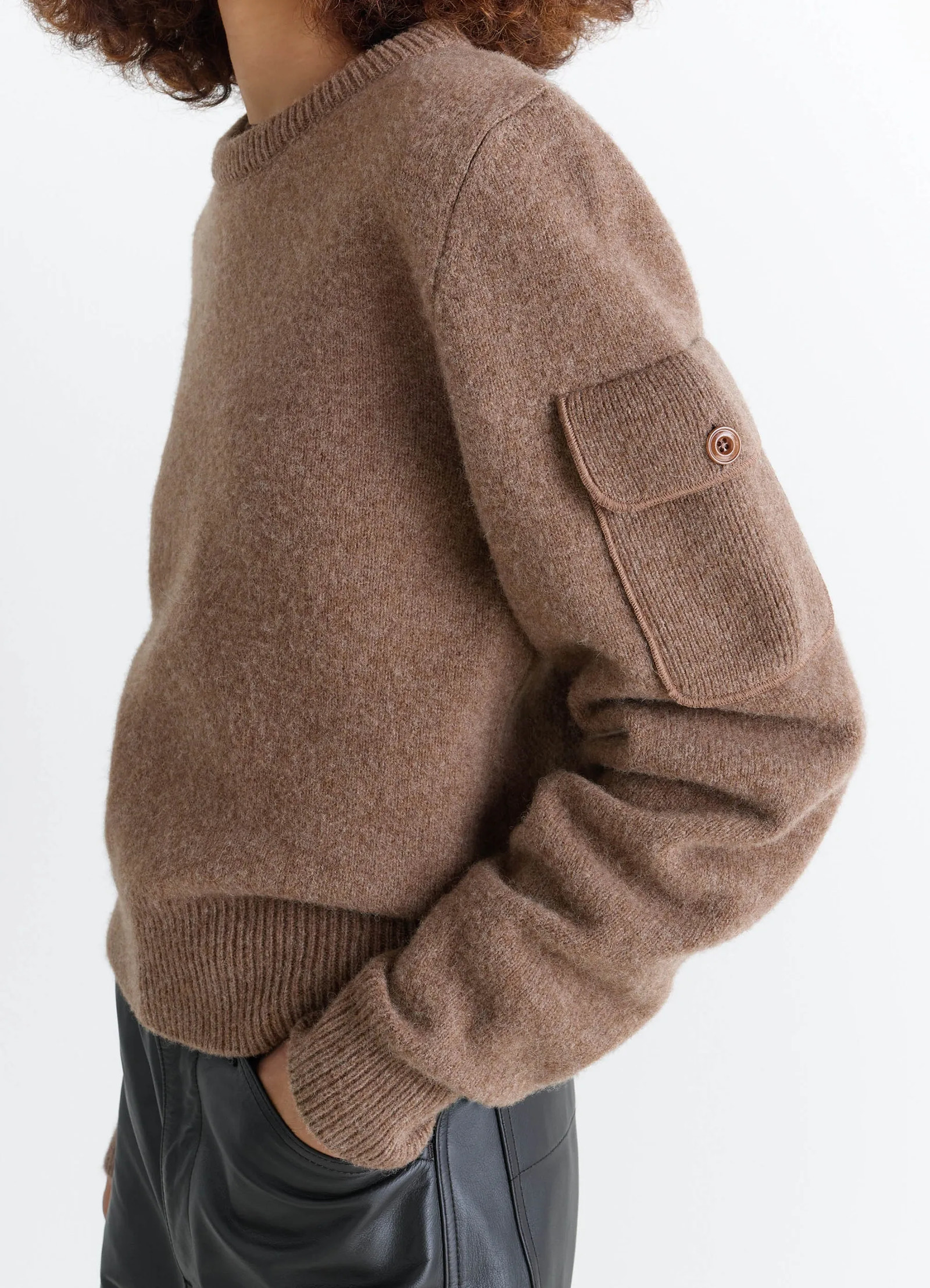 Shetland wool pocketed sweater in brown shetland wool, model shot, side detail shot pocketed sleeve detail