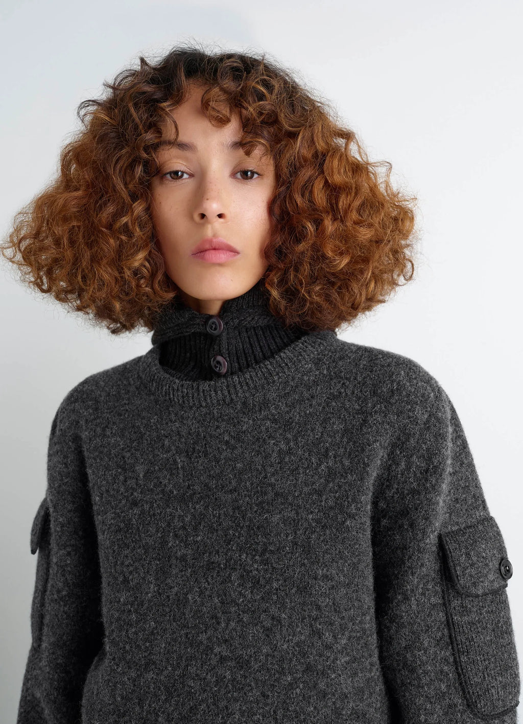 SWEATER WITH POCKETS in Shetland wool grey, model shot, close-up view buttoned collar detail
