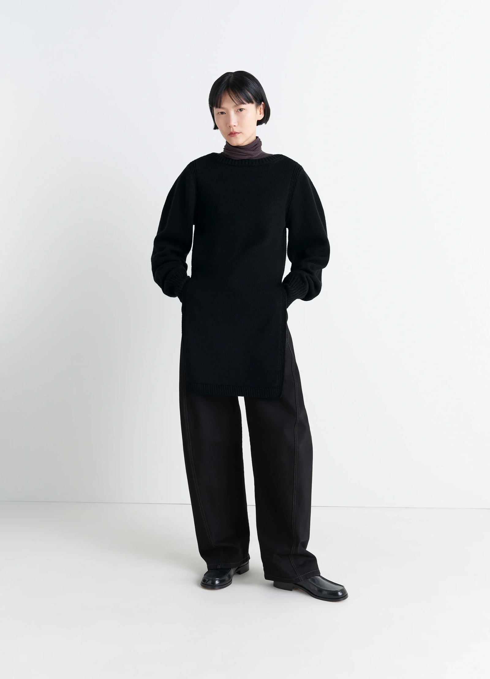 Sweater with slits in combed wool black, model shot, front view long slit design