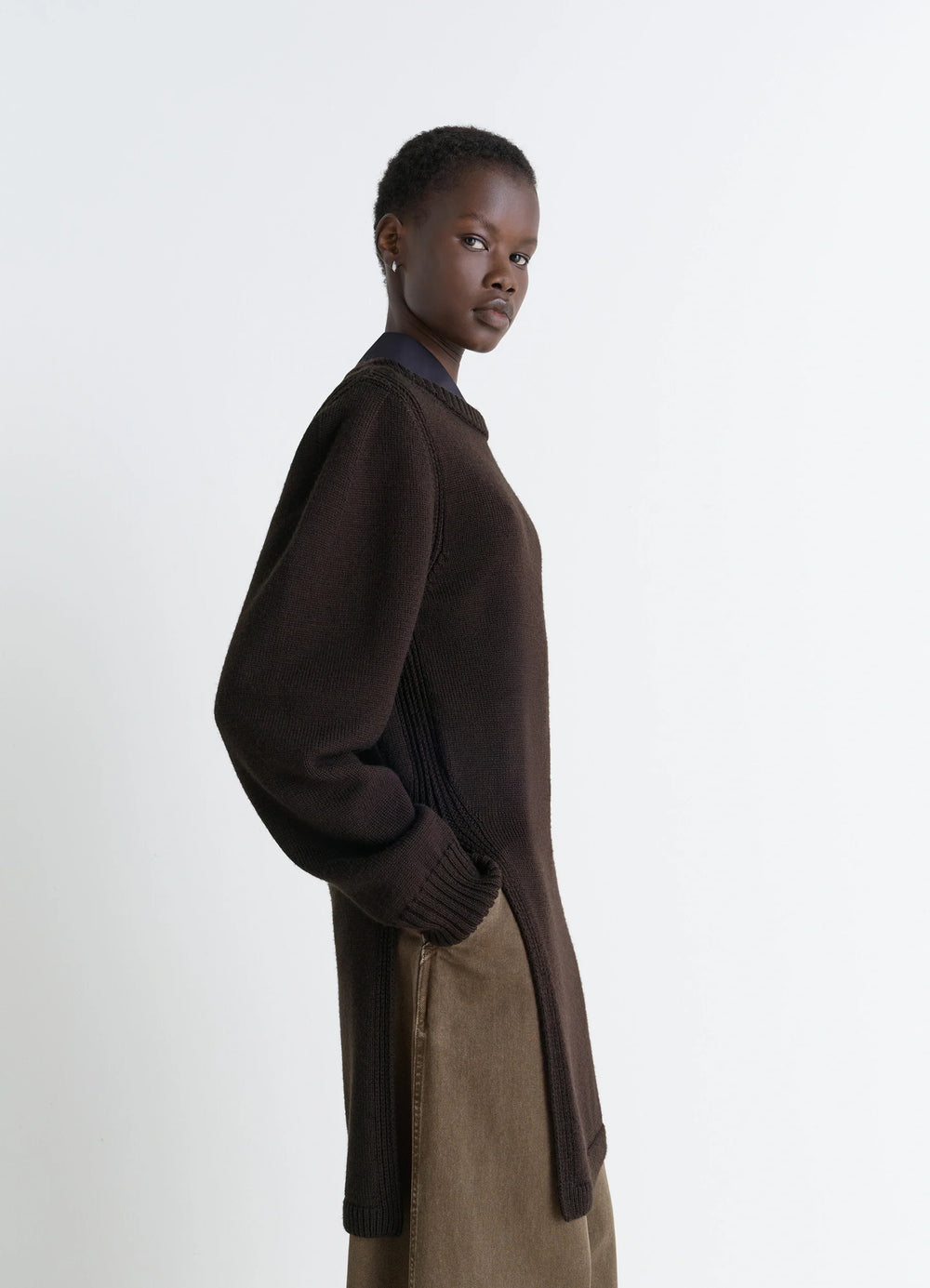 Sweater with Slits in Dark Brown Combed Wool, model shot, side view soft texture, relaxed fit