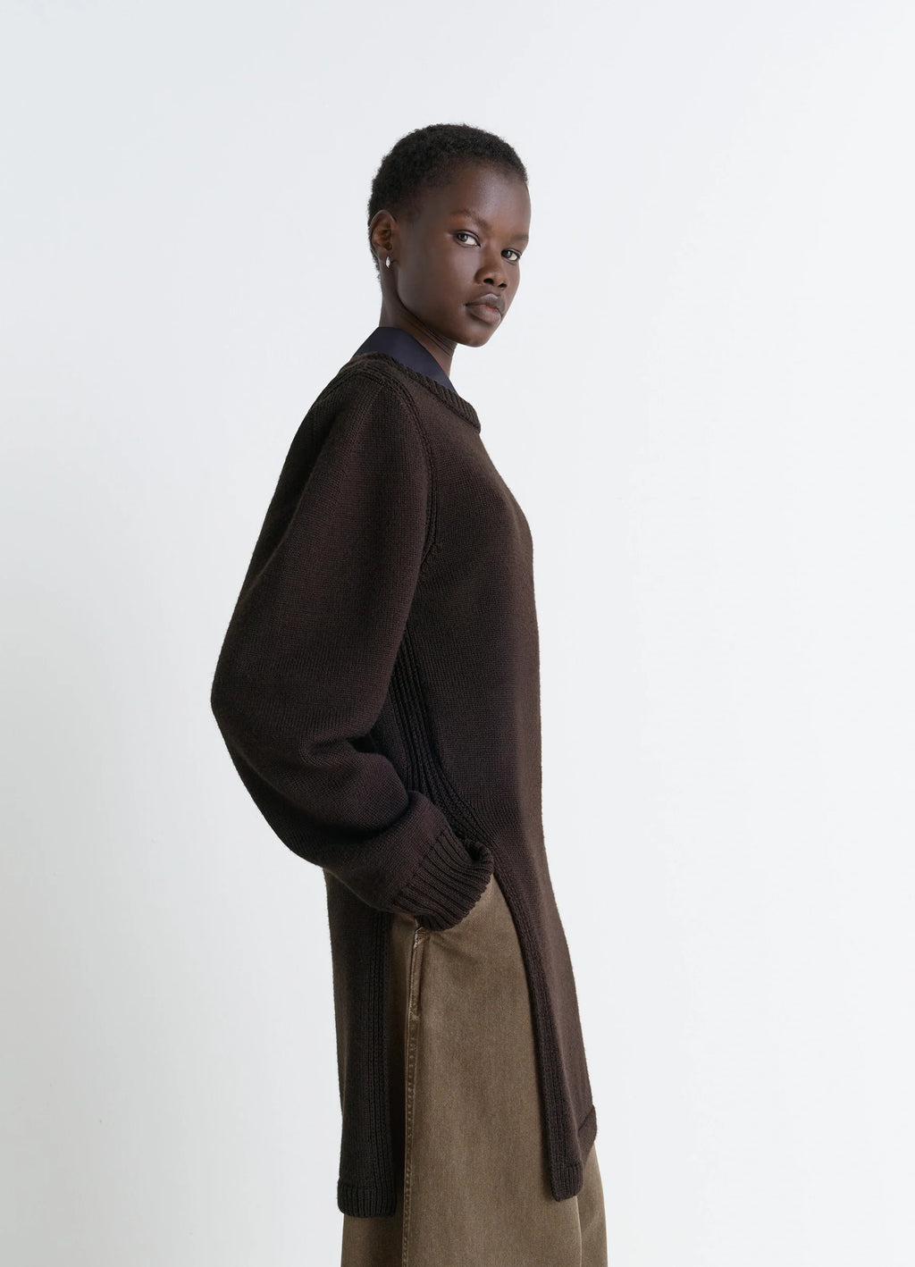 Sweater with Slits in Dark Brown Combed Wool, model shot, side view soft texture, relaxed fit