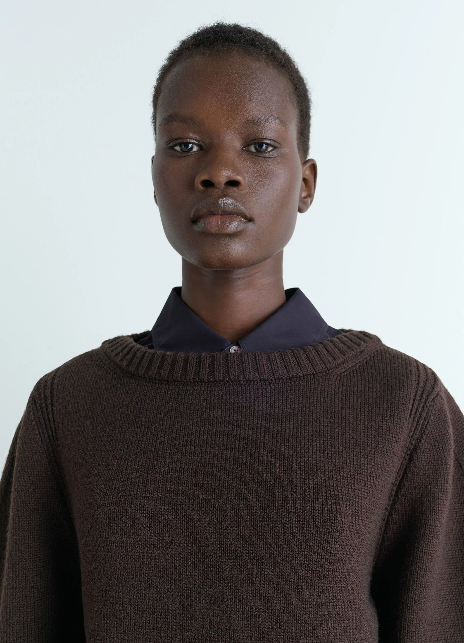 Sweater with slits in dark brown combed wool, model shot, close-up view ribbed collar detail