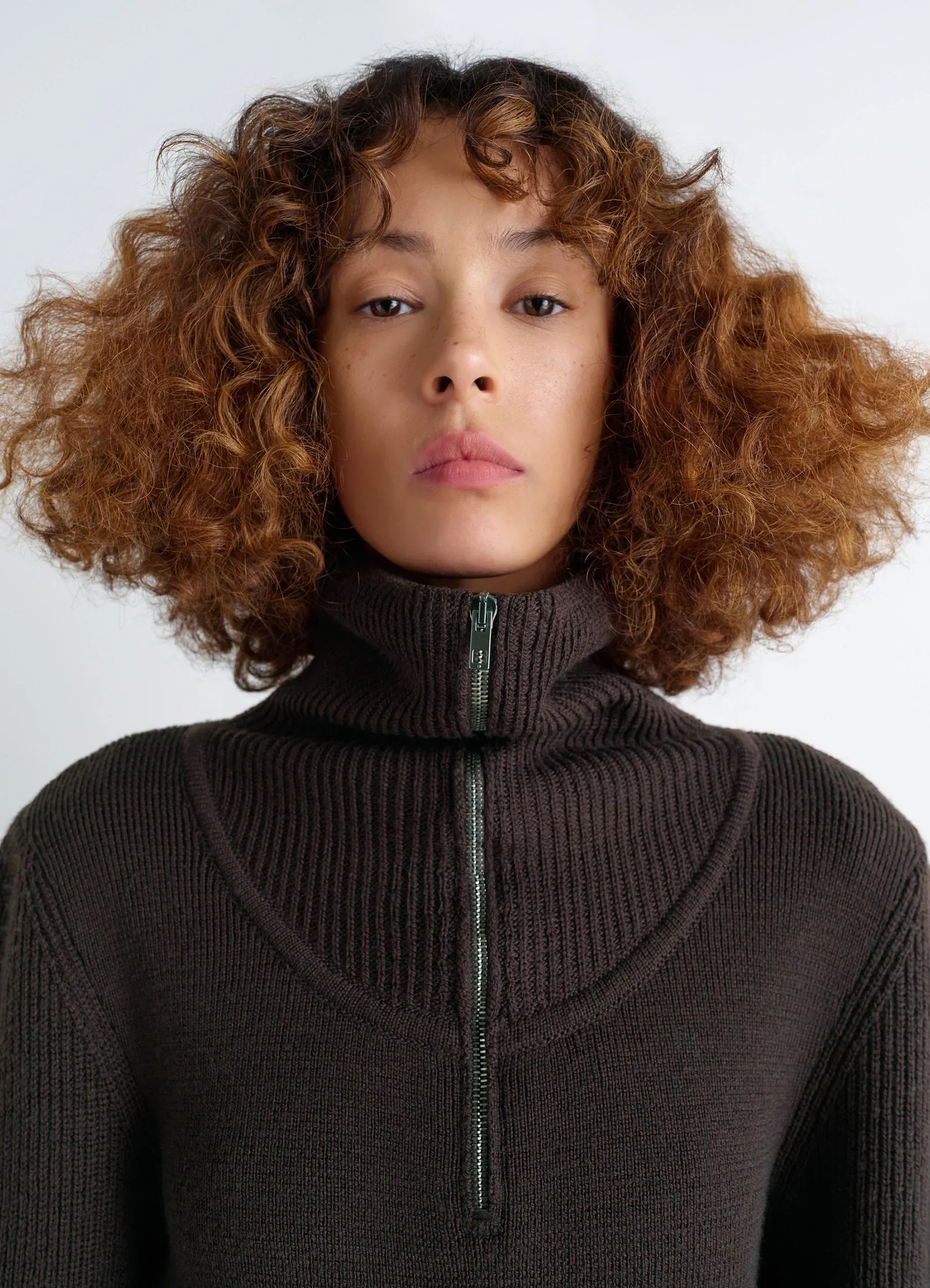 Zipped sweater in combed wool, model shot, close-up detail view high collar zip feature