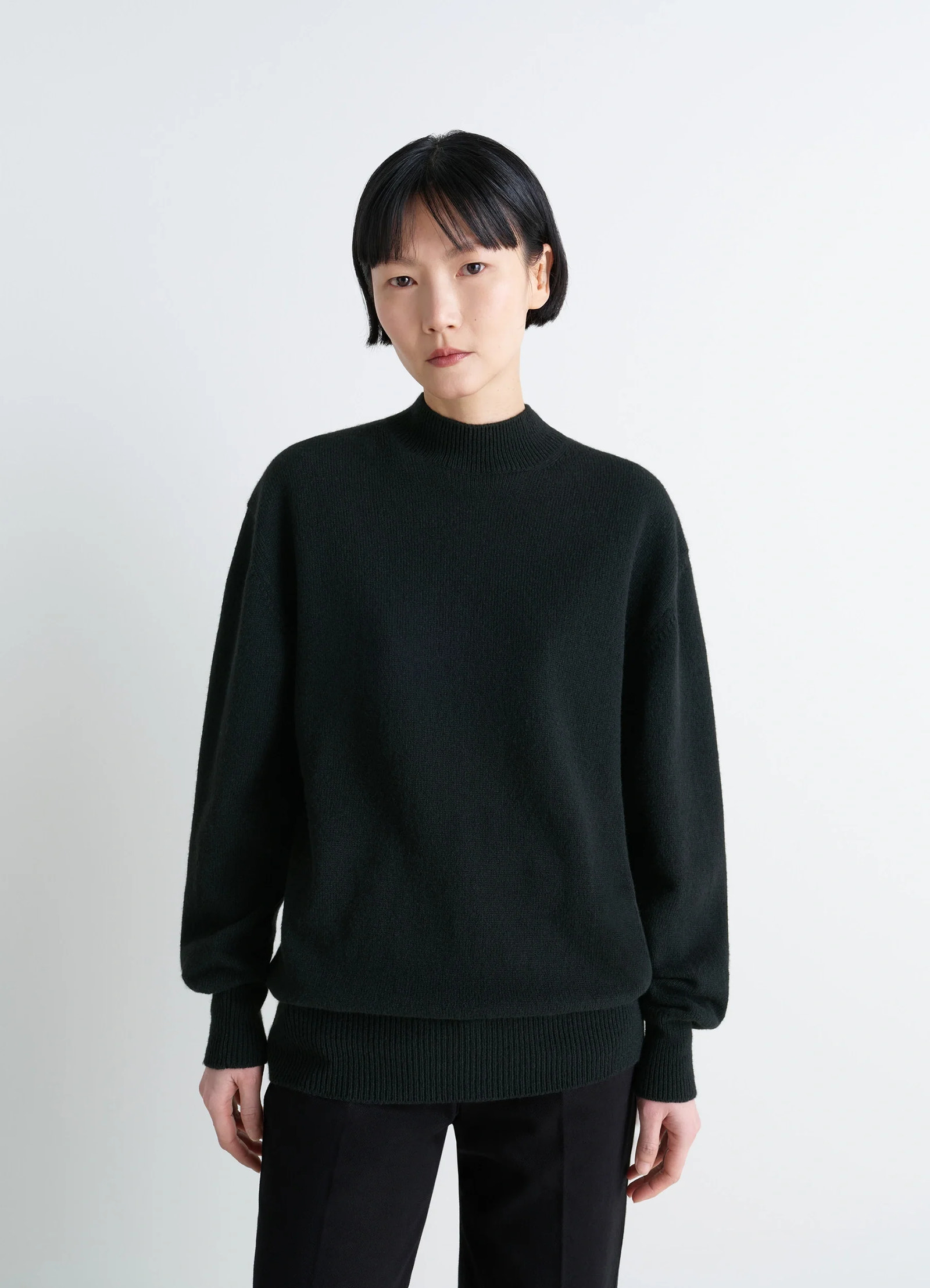 Mock neck sweater in alpaca yak wool, model shot, close-up view ribbed hem