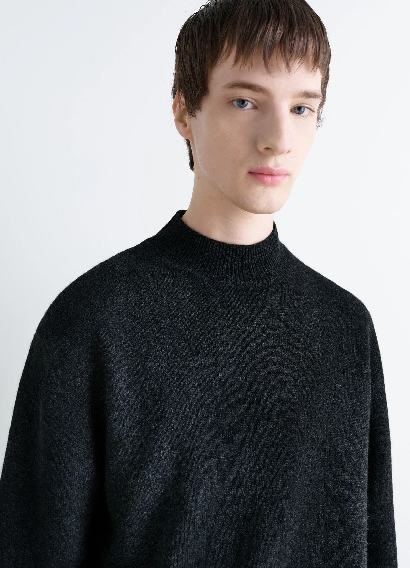 Mock neck sweater in black alpaca yak wool, model shot, close-up view ribbed mock neck