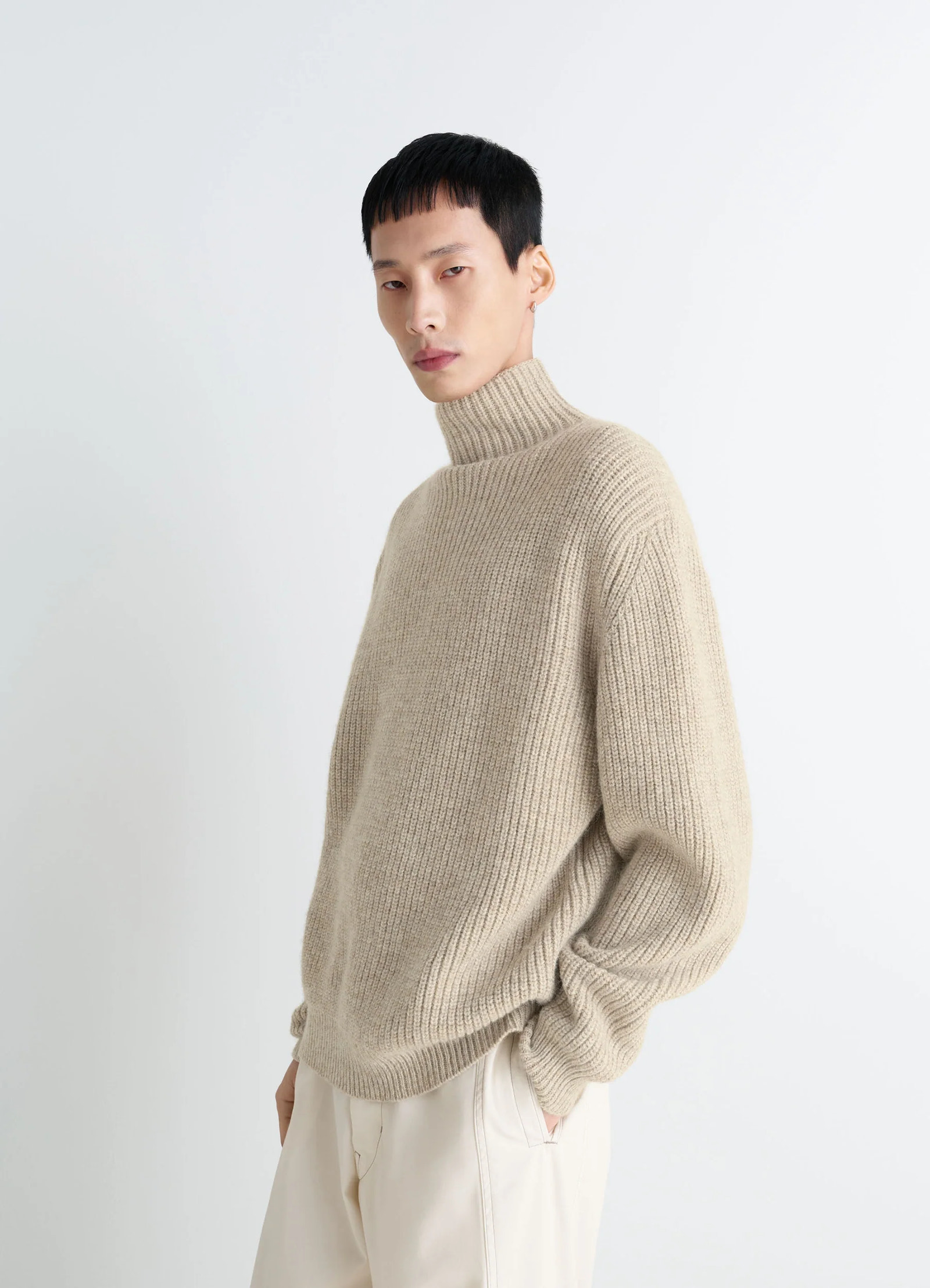 High neck sweater in alpaca yak wool blend, model shot, side view loose fit