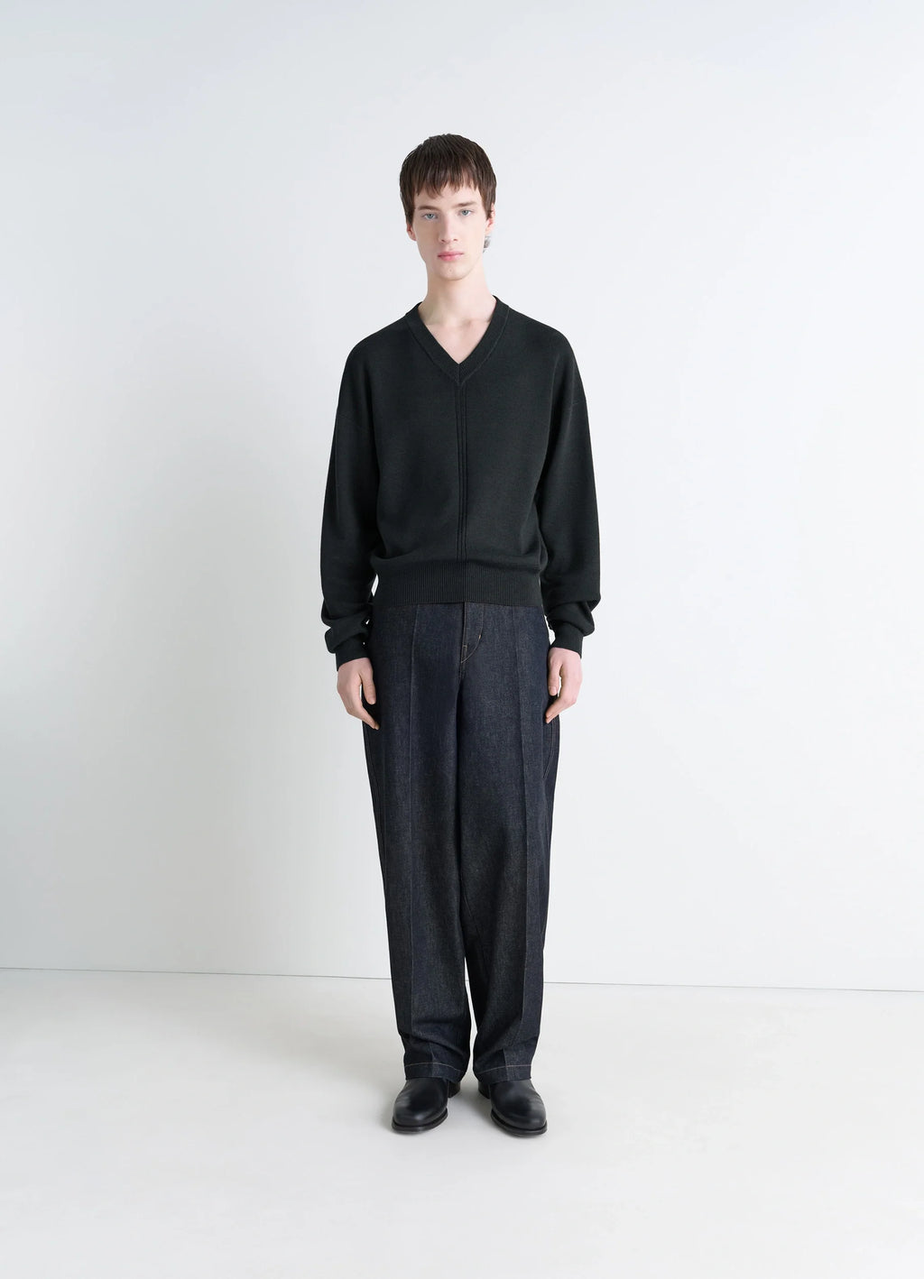 Lemaire V Neck Sweater in Blended Merino Wool in Black, model shot, full body porte dropped shoulders