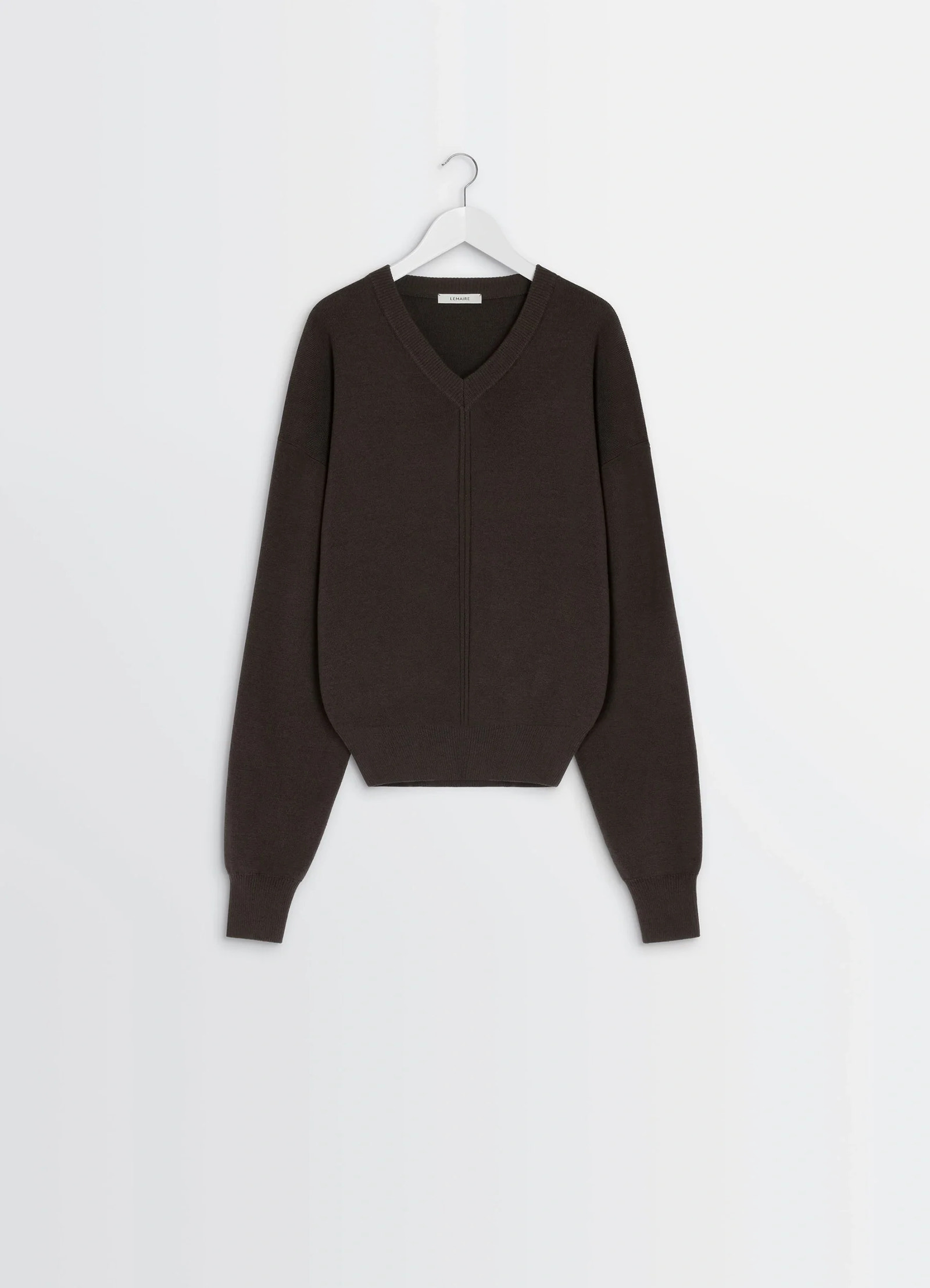 Lemaire v neck sweater in blended merino wool, product shot, hanging display view rolled cuffs visible