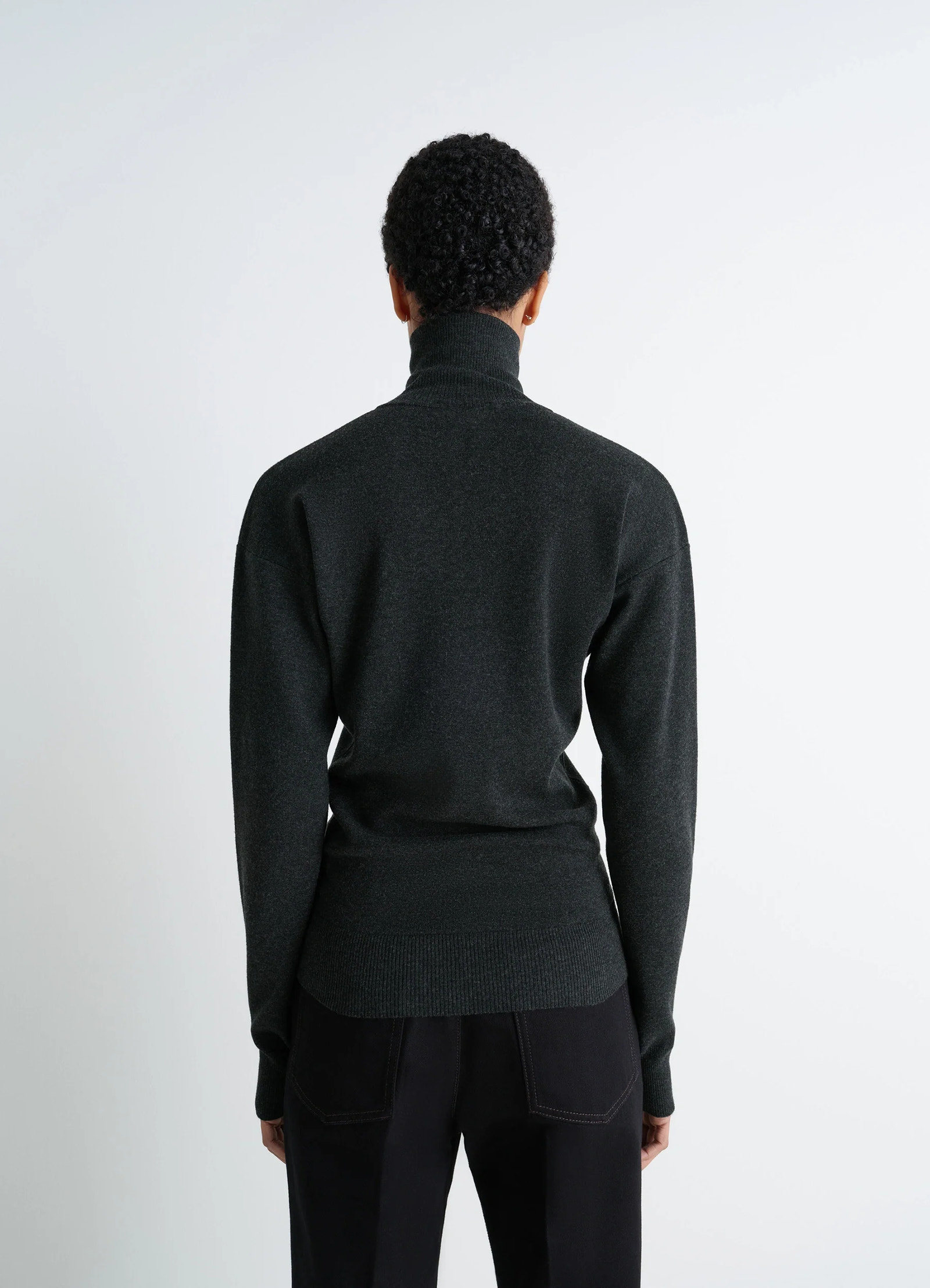 Lemaire buttoned fitted cardigan in dark heather mercerized wool, model shot, back view ribbed cuffs and hem