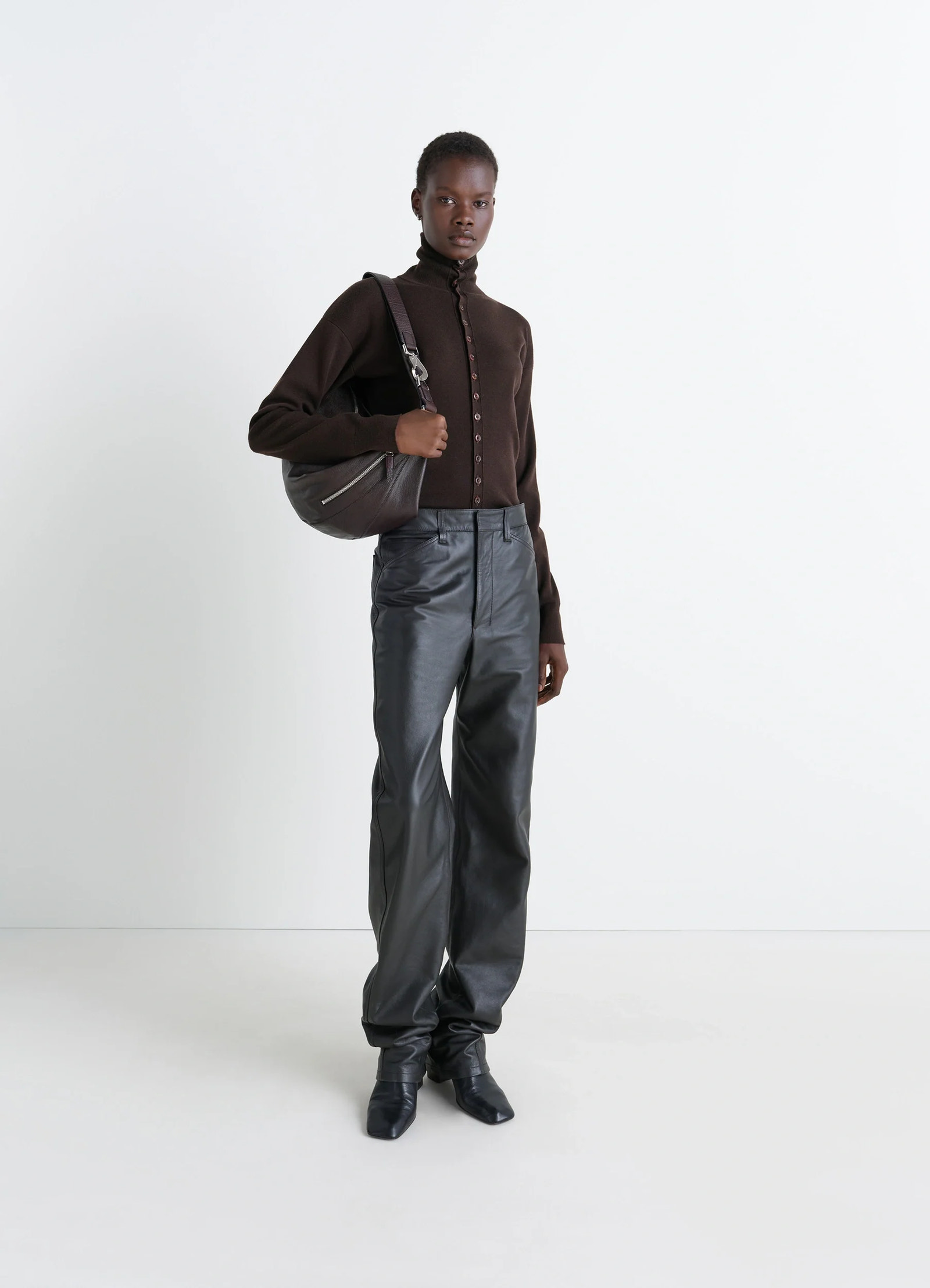 Lemaire buttoned fitted cardigan in brown mercerized wool, model shot, three-quarter view high neck, long sleeves