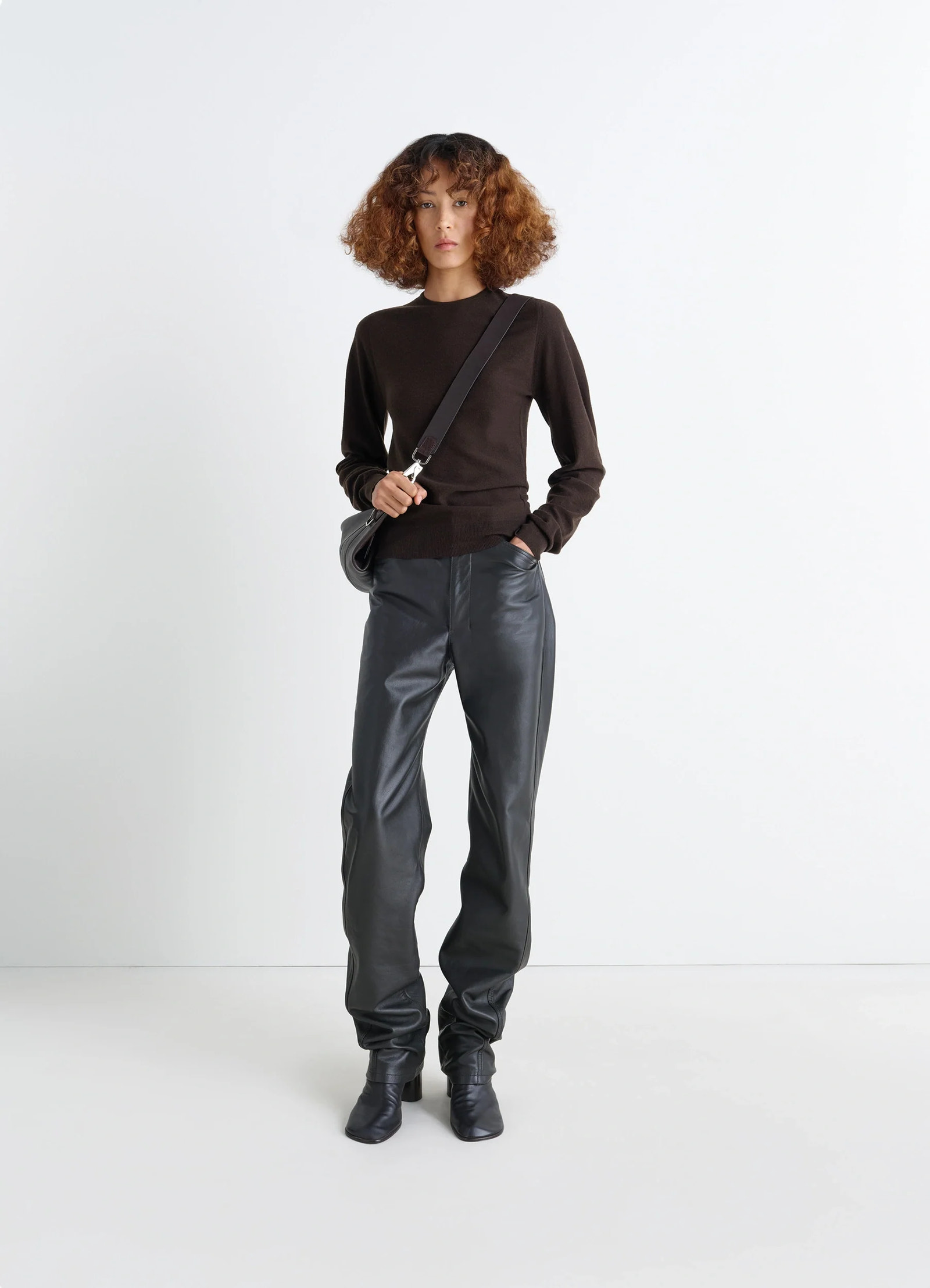 Lemaire crew neck sweater in lightly mercerized wool, model shot, three-quarter view subtle sheen