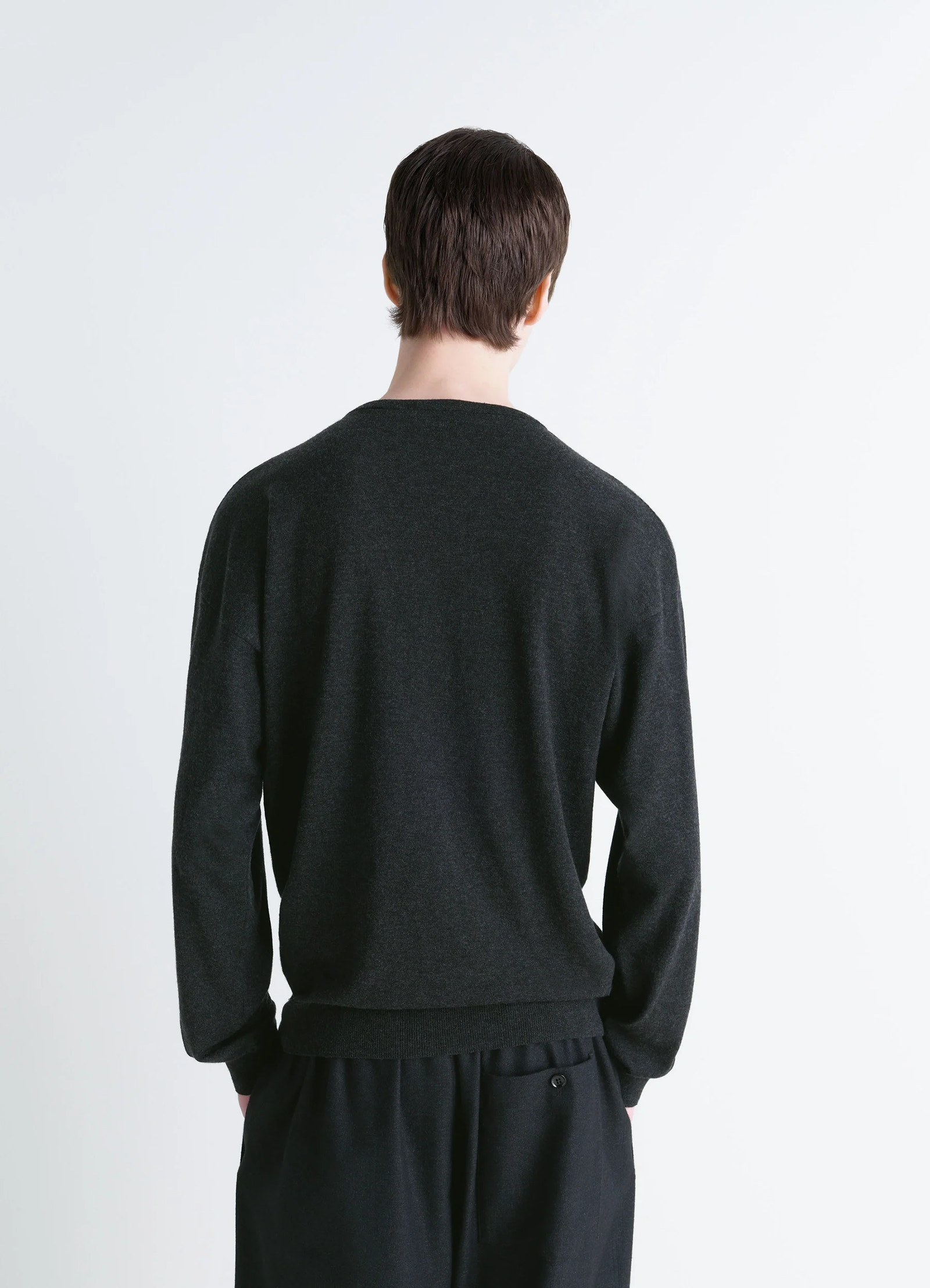Lemaire crew neck sweater in lightly mercerized wool, dark gray, model shot, back view dropped shoulders