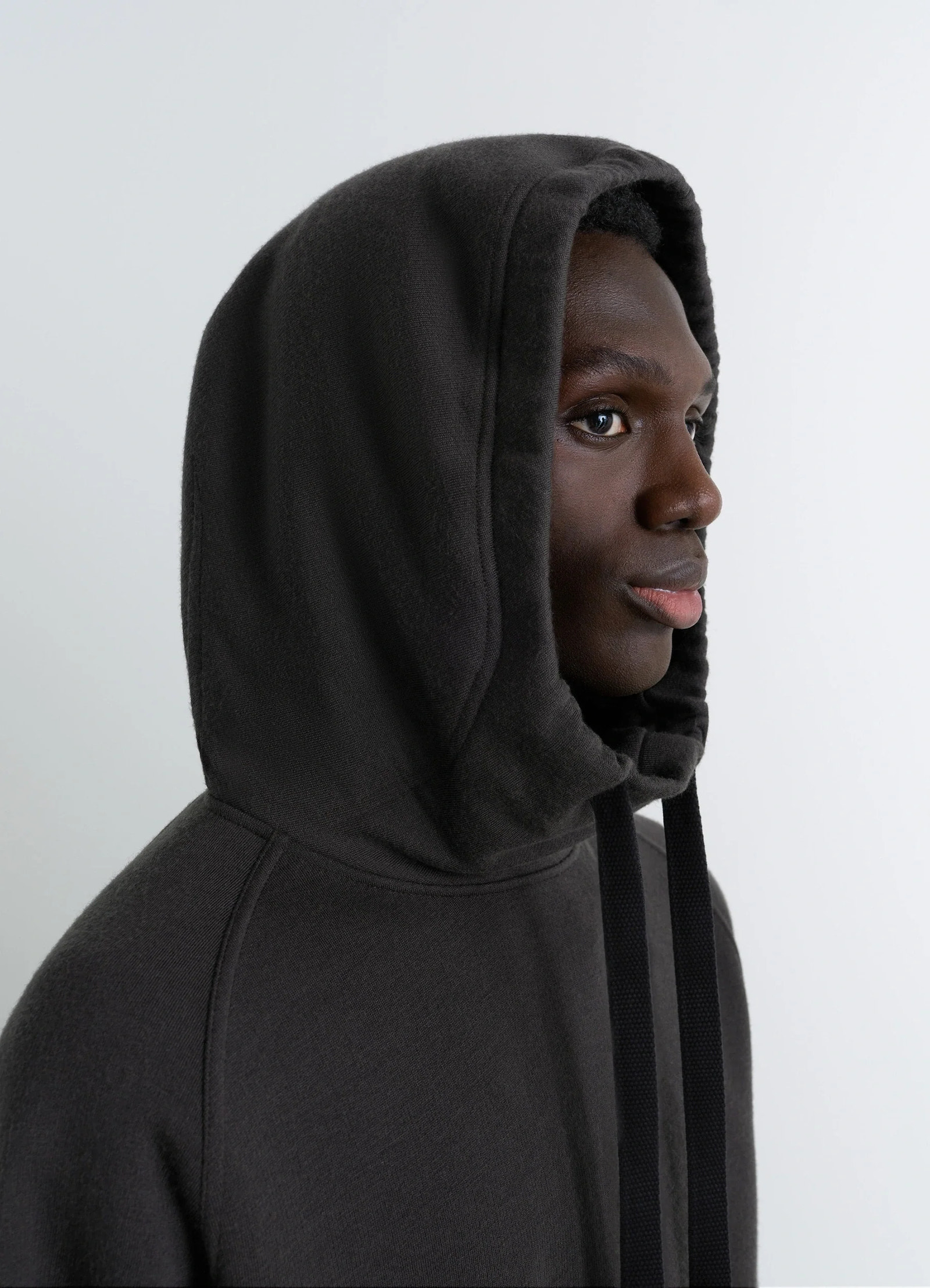 Lemaire hooded sweatshirt in wool cotton blend, model shot, profile view hood detail