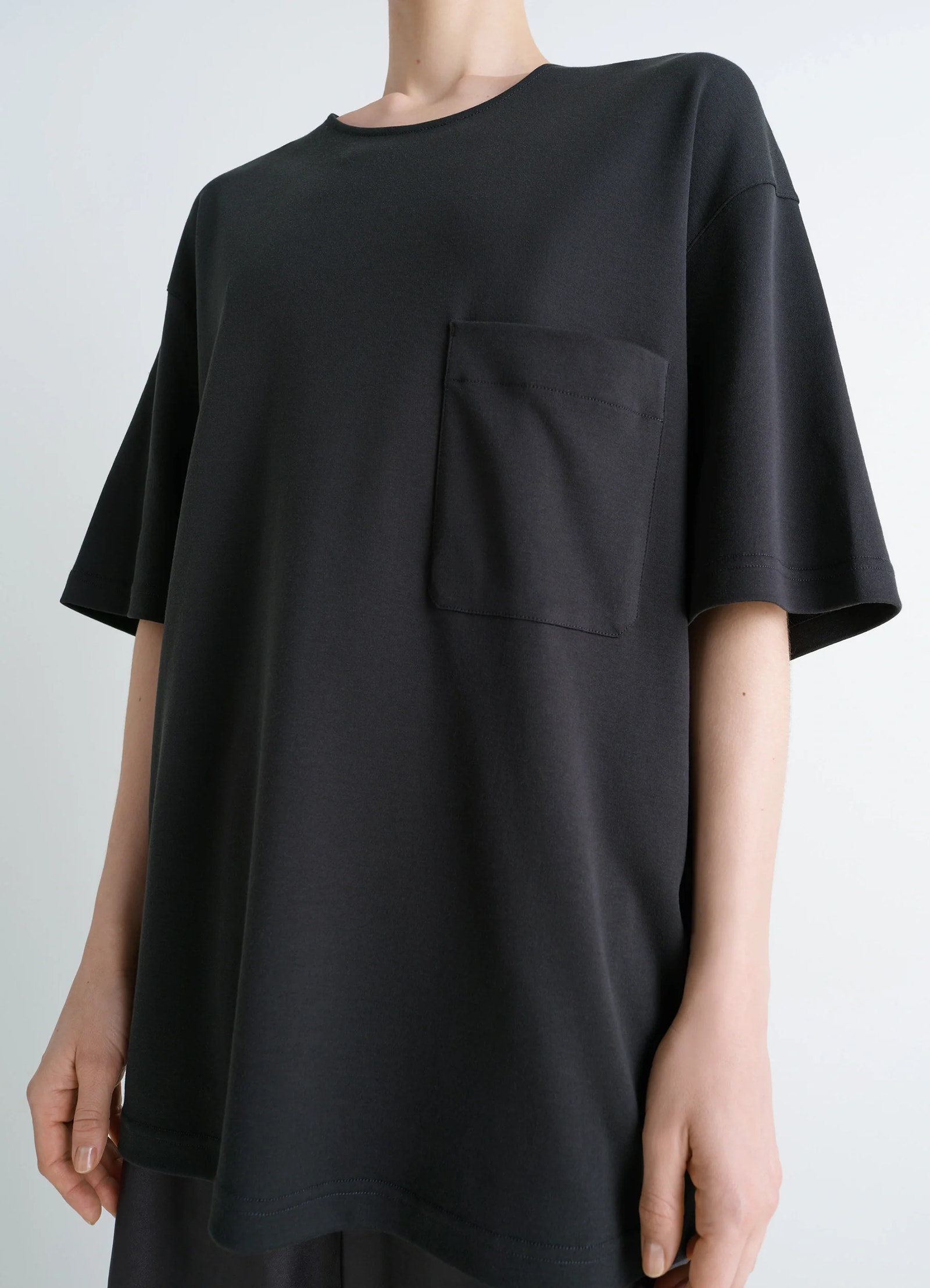 Lemaire casual short-sleeved t-shir in black cotton and silk-blend jersey, model shot, close-up view oversized chest pocket