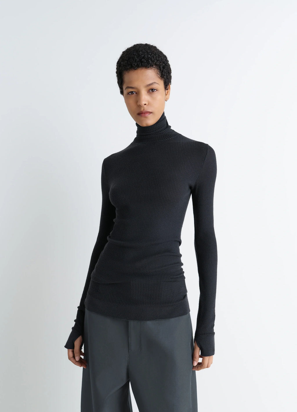 Lemaire Seamless High Neck Top in Black Finely Ribbed Merino Wool, model shot, Front view Fitted cut