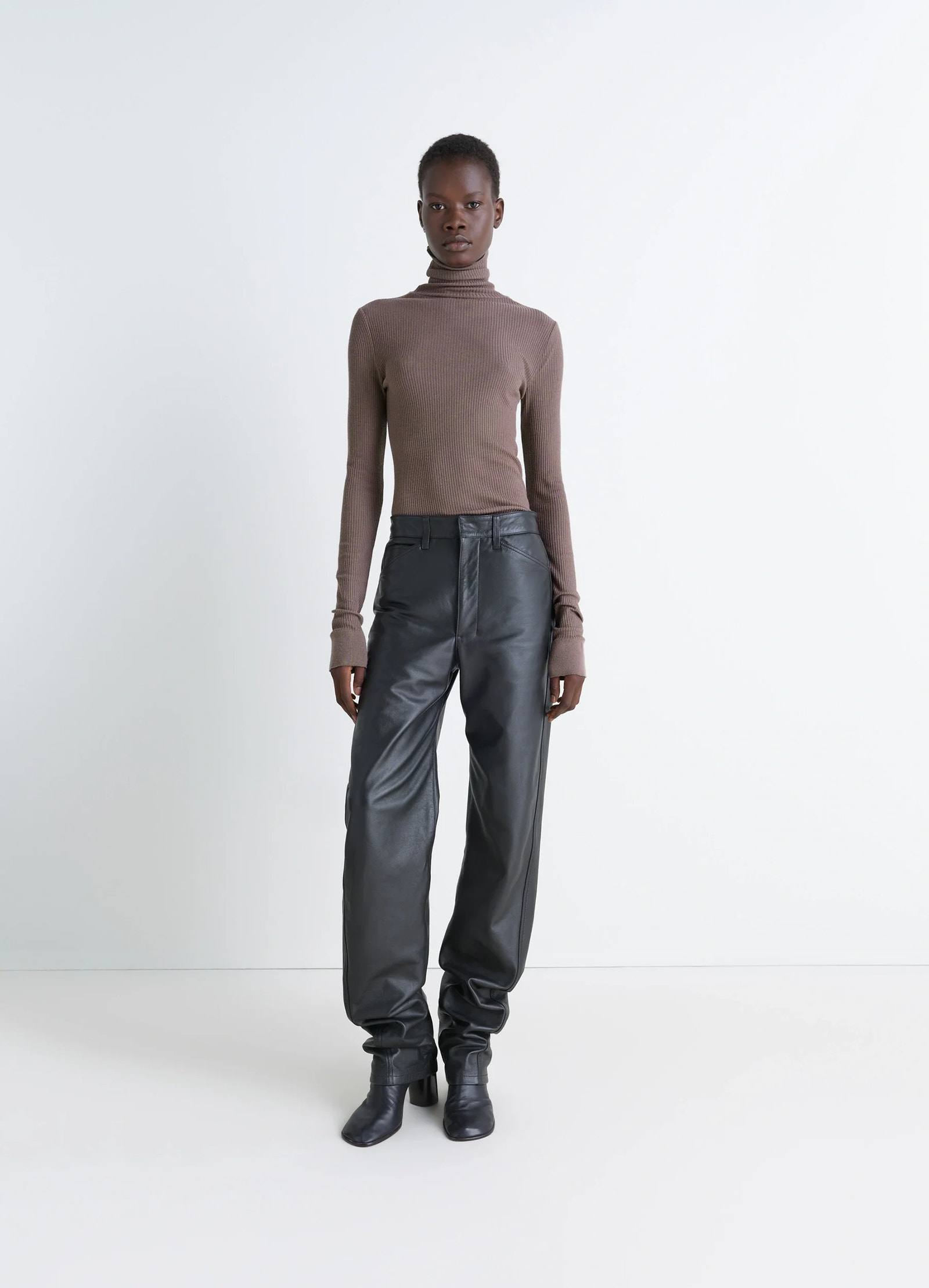 Lemaire seamless high neck top in ribbed merino wool, model shot, side view long sleeves