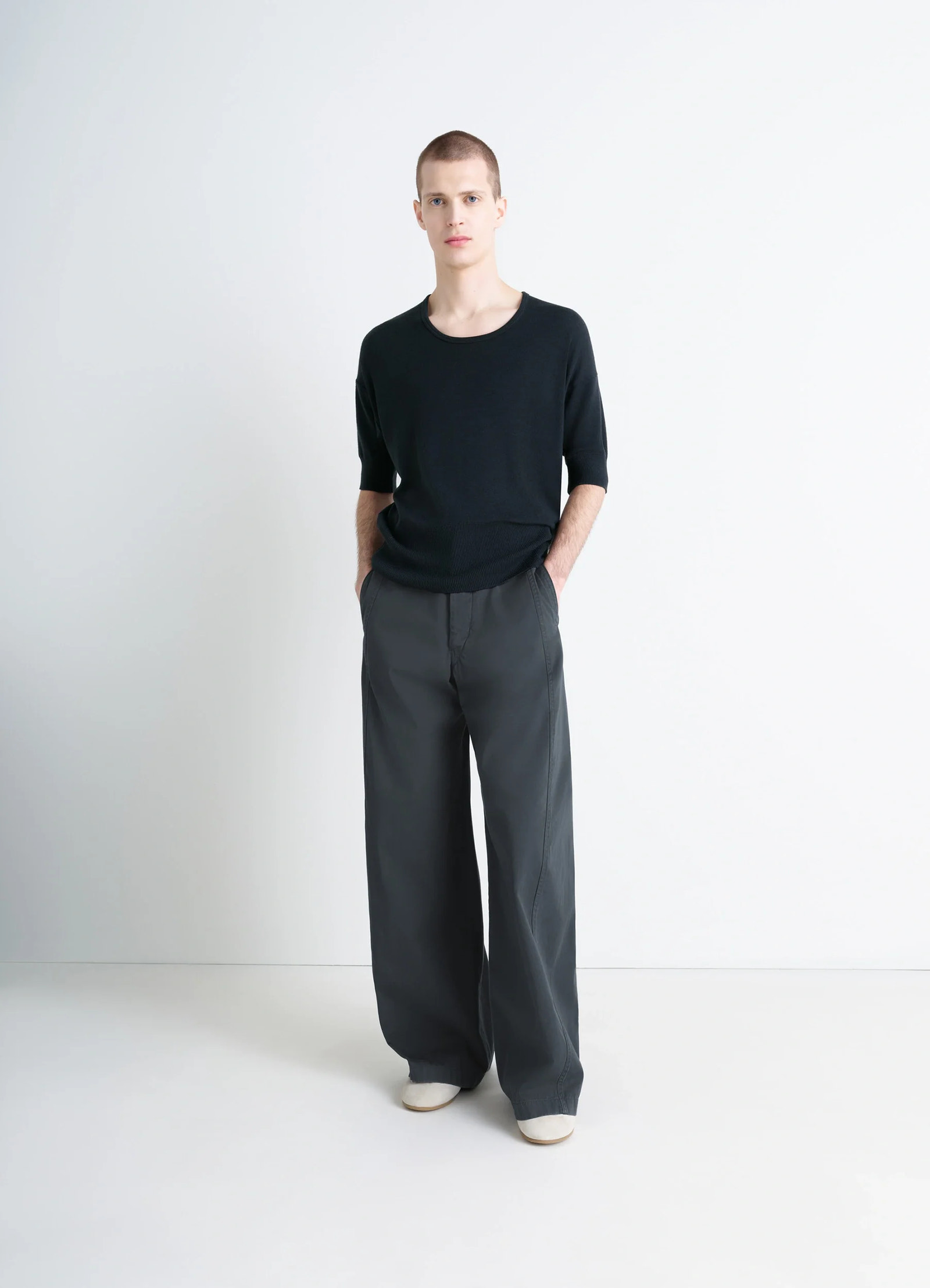 Lemaire short sleeves top in black ribbed merino wool, model shot, three-quarter view relaxed drape
