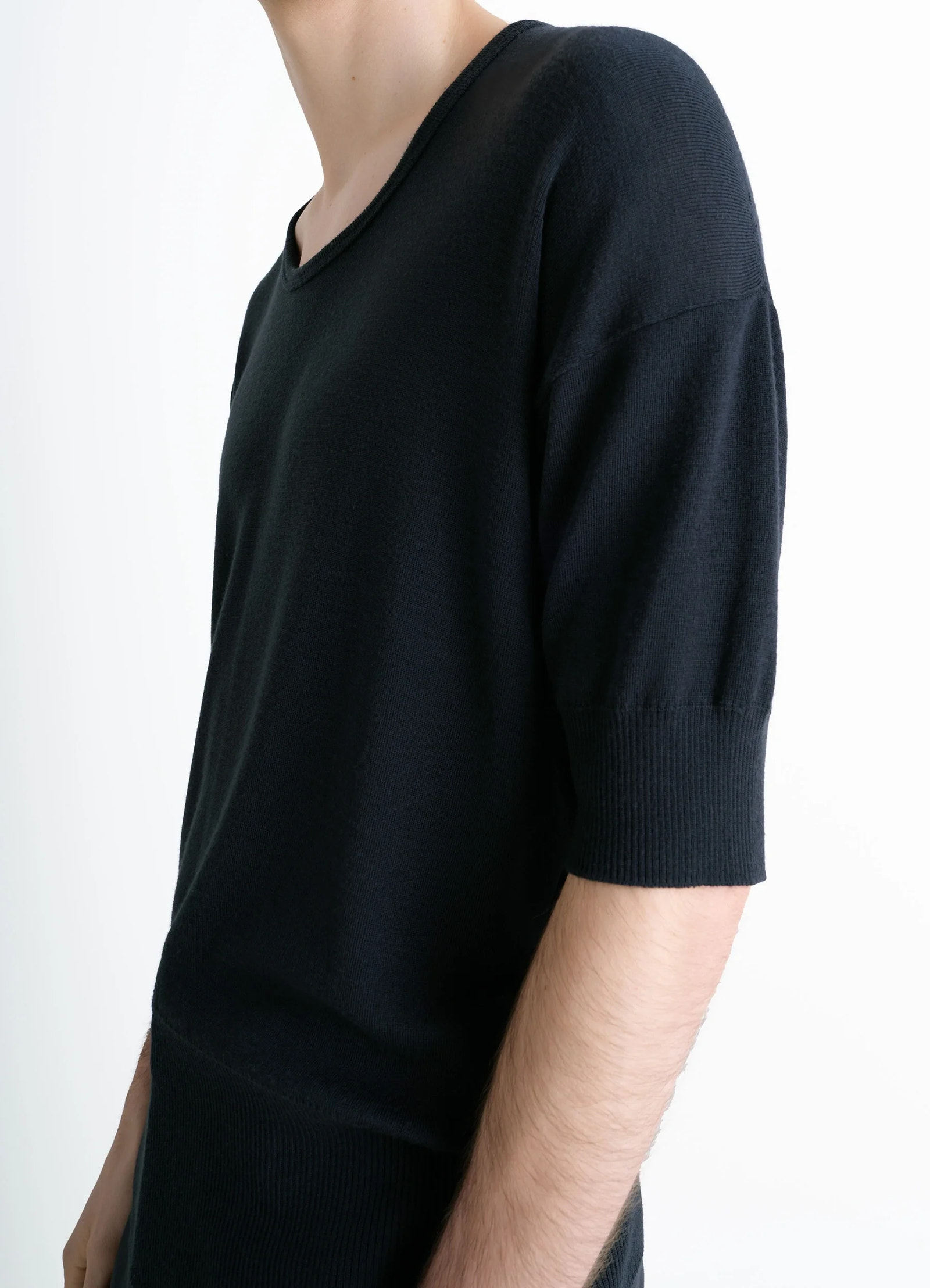 Lemaire short sleeves top in black ribbed merino wool, model shot, side detail view ribbed sleeve hem