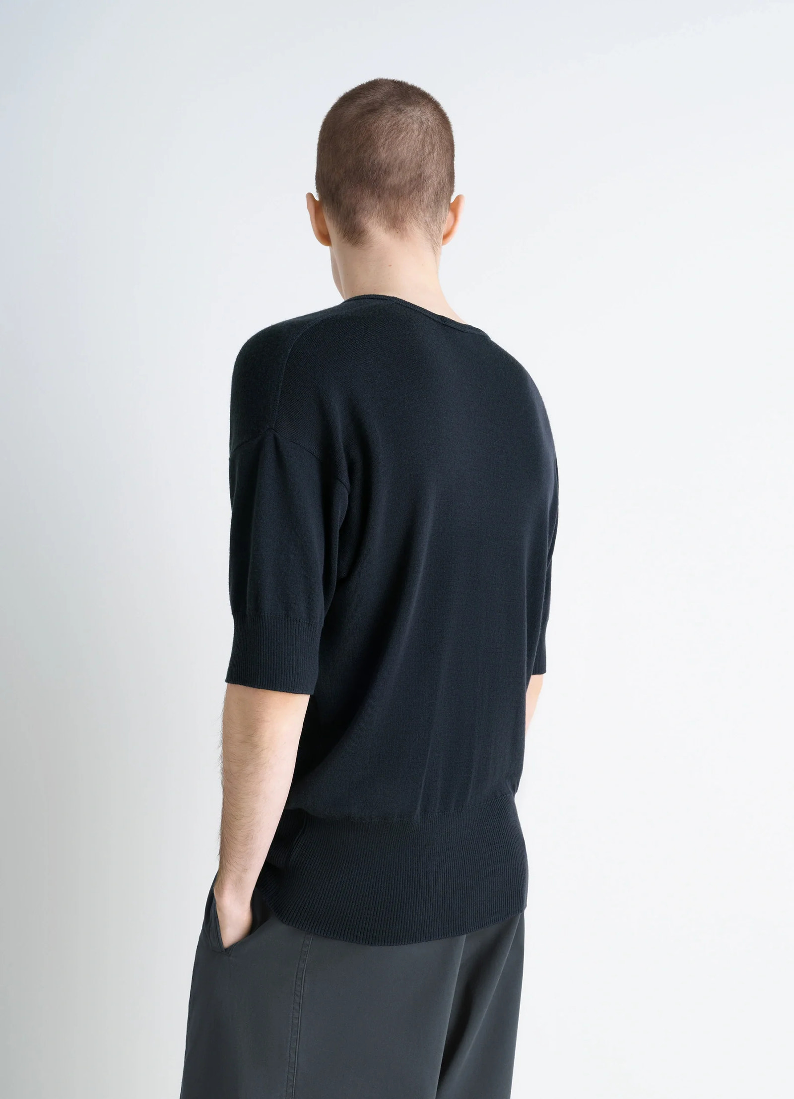 Lemaire short sleeves top in black ribbed merino wool, model shot, back view dropped shoulder seam