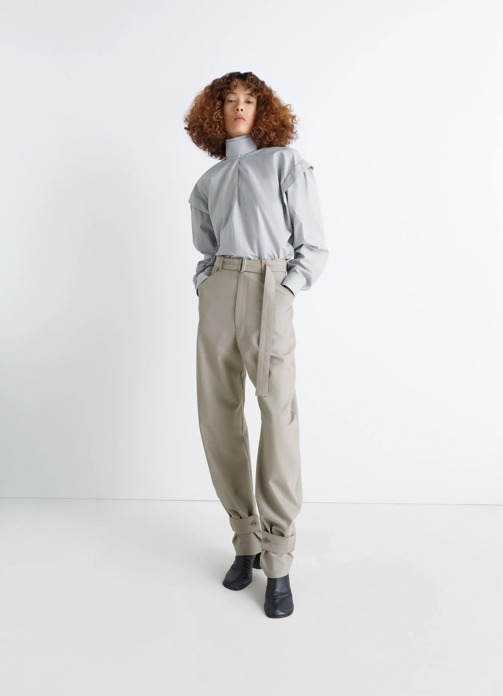 Ascot blouse in light patina washed cotton-silk, model shot, three-quarter view tucked into wide pants