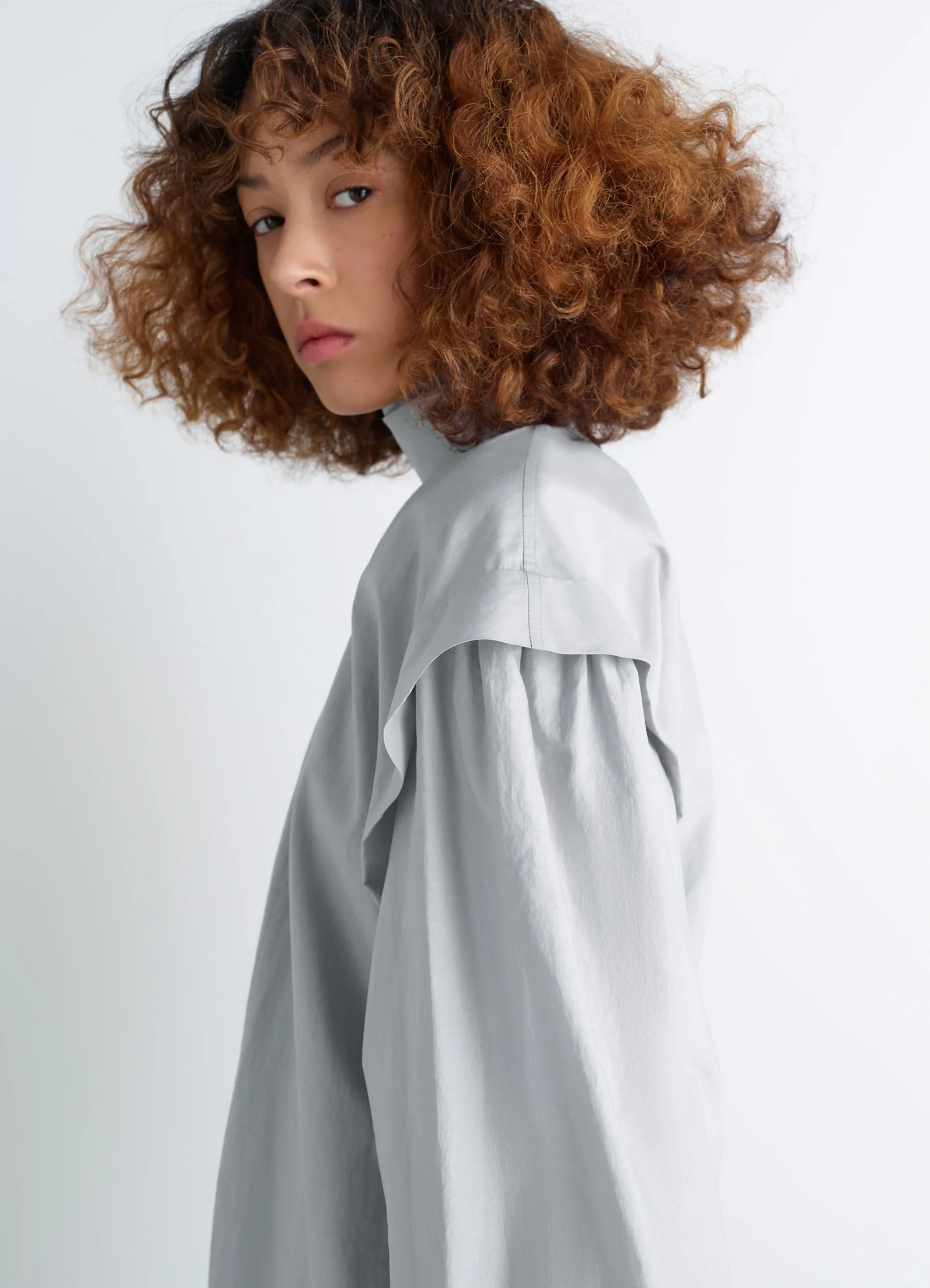 Ascot blouse in light patina washed cotton-silk, model shot, side profile draped shoulder, puffed sleeve