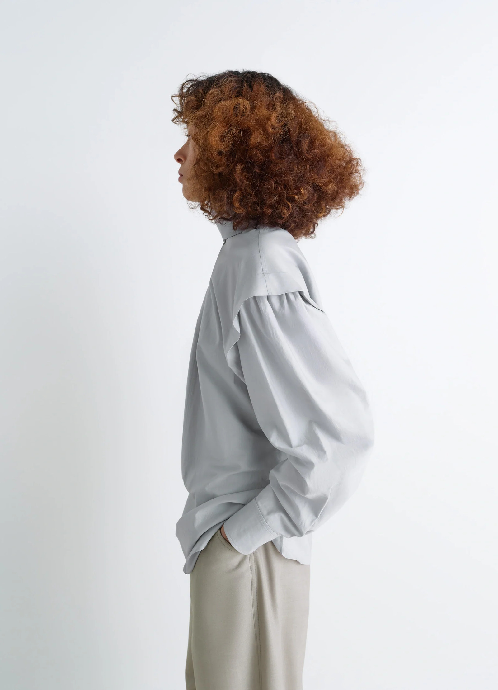 Ascot blouse in light patina washed cotton-silk, model shot, left side view hand in pocket