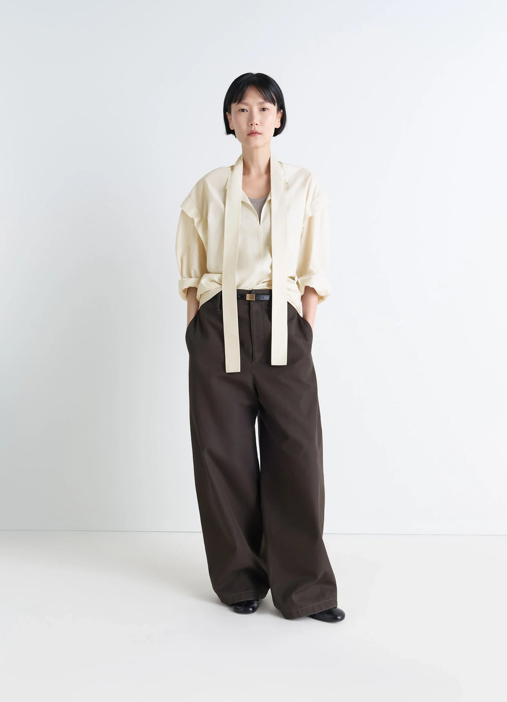Lemaire Ascot Blouse in Ivory Washed Cotton-Silk, model shot, front three-quarter view rolled sleeves with ascot tie