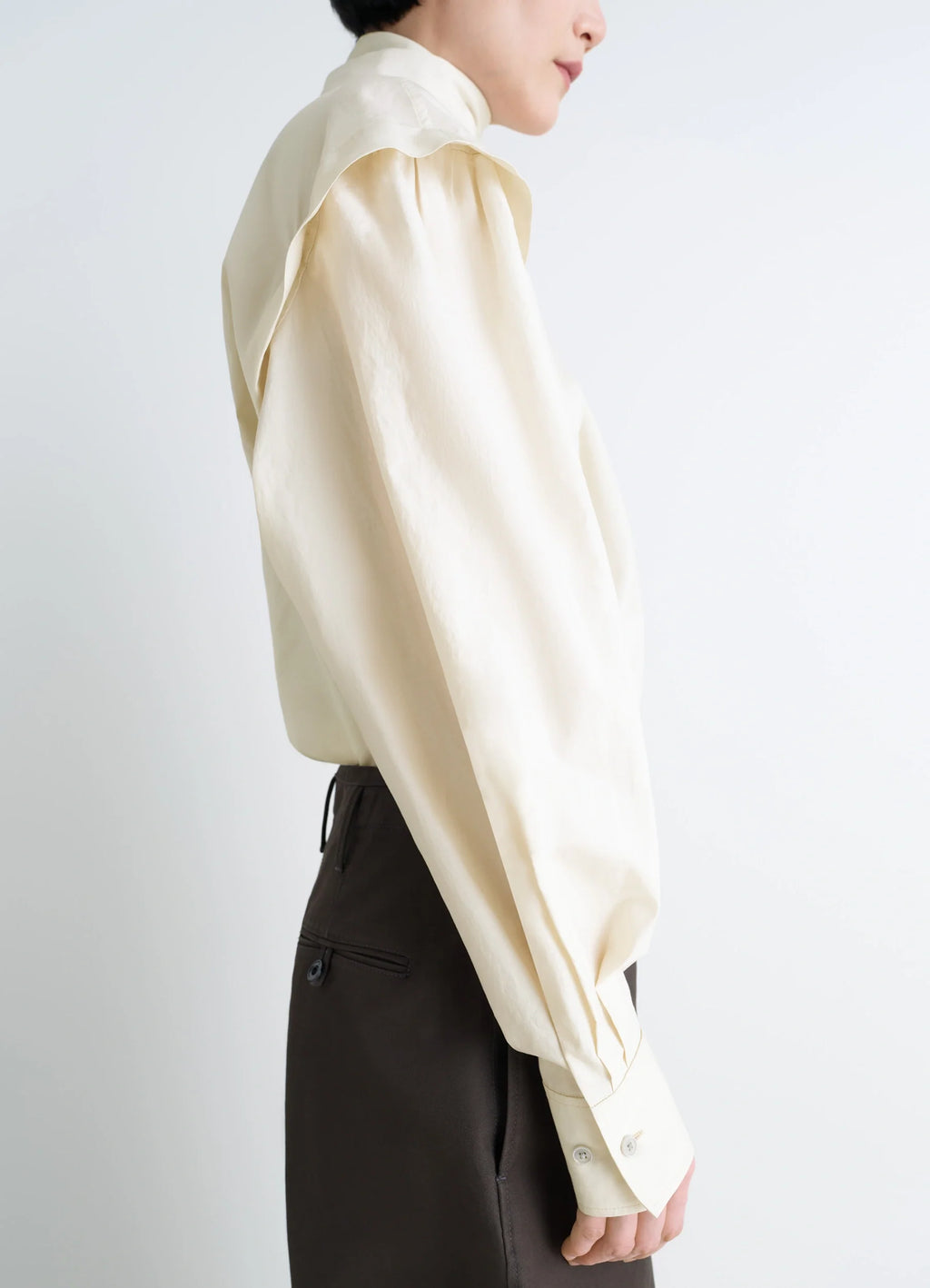 Lemaire Ascot Blouse in Ivory Washed Cotton-Silk, model shot, side view puffed sleeves with cuffs